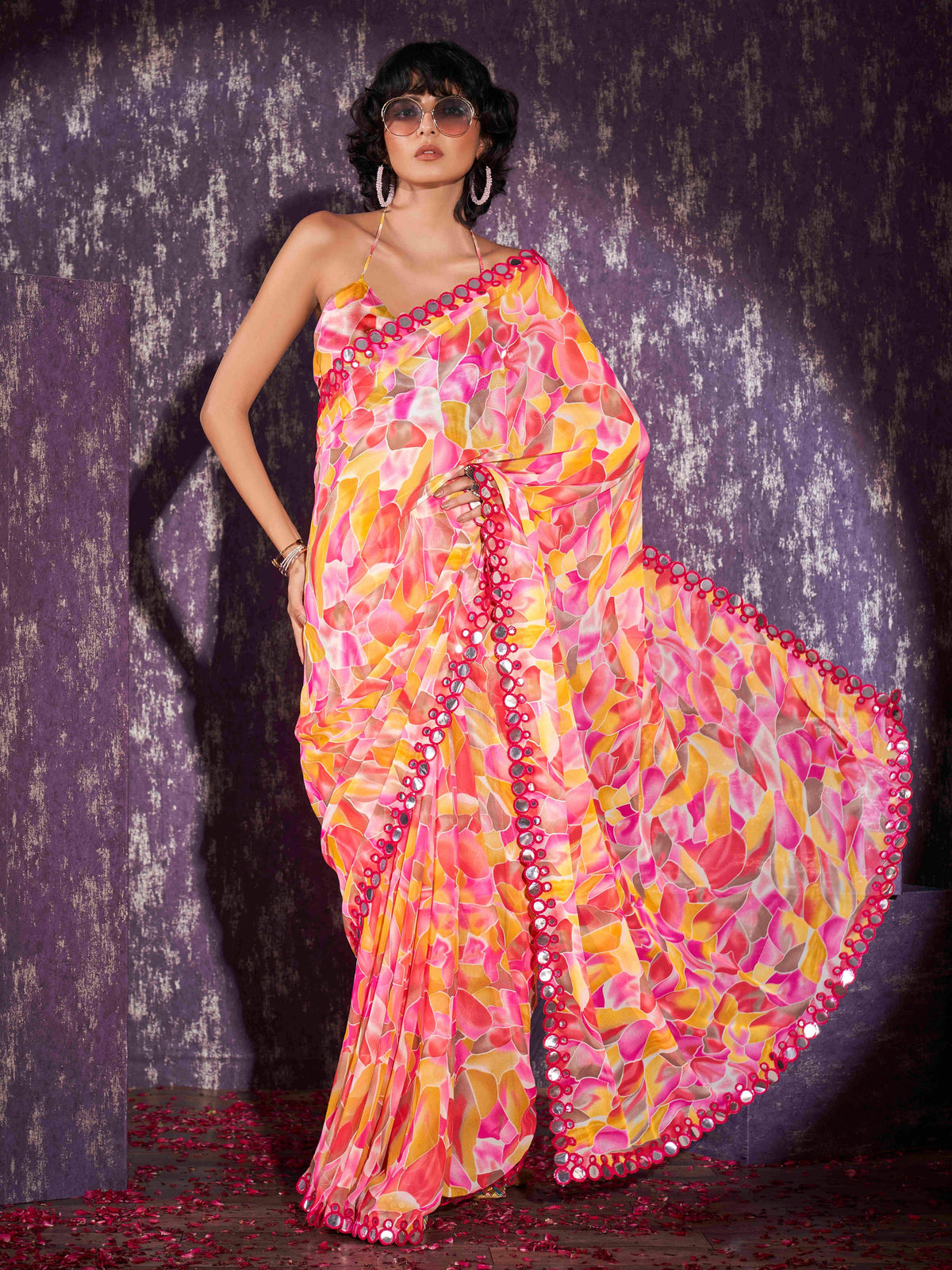 Pink and yellow colored georgette saree with faux mirror embroiderd scalloped lace