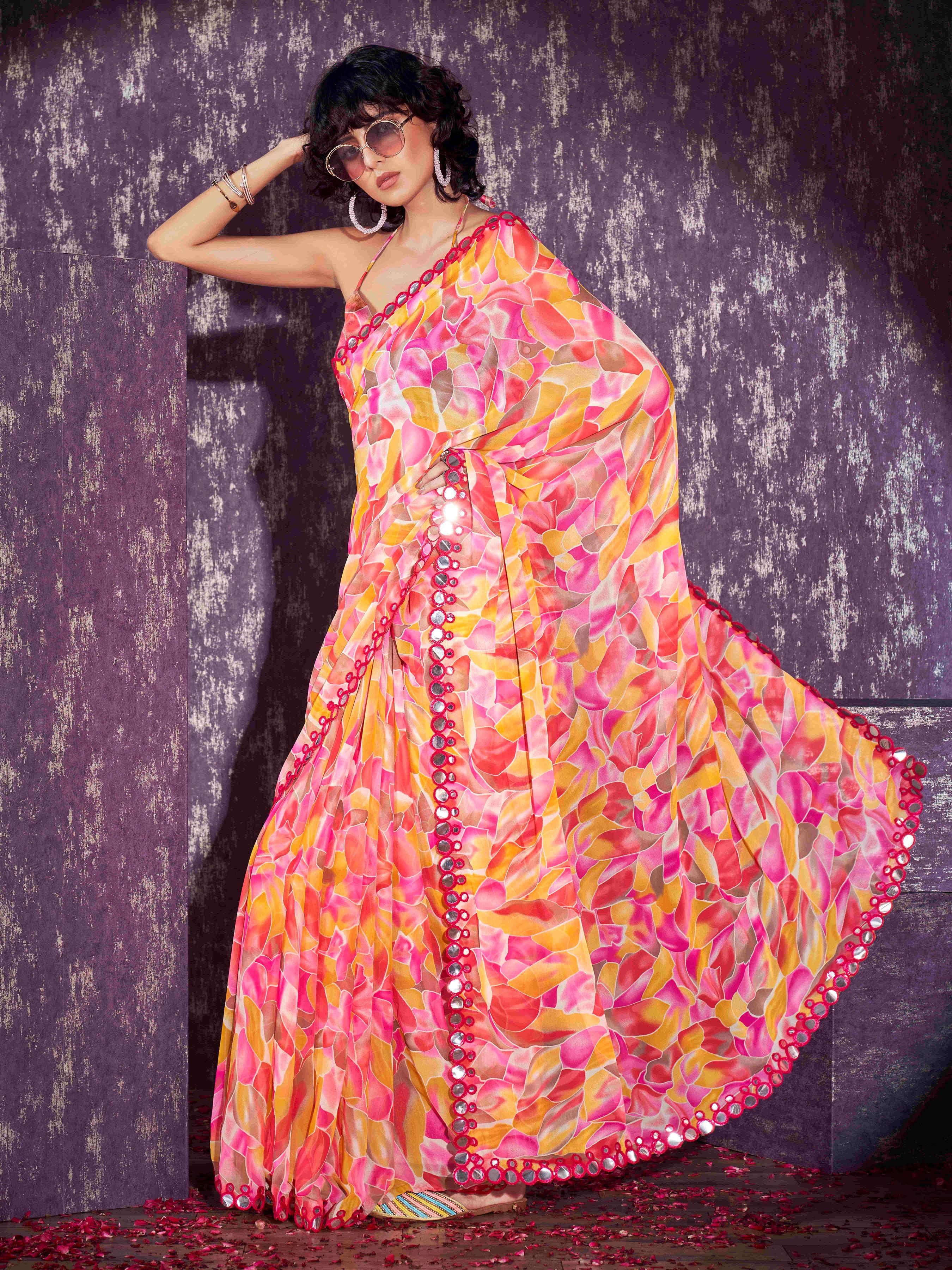 Pink and yellow colored georgette saree with faux mirror embroiderd scalloped lace