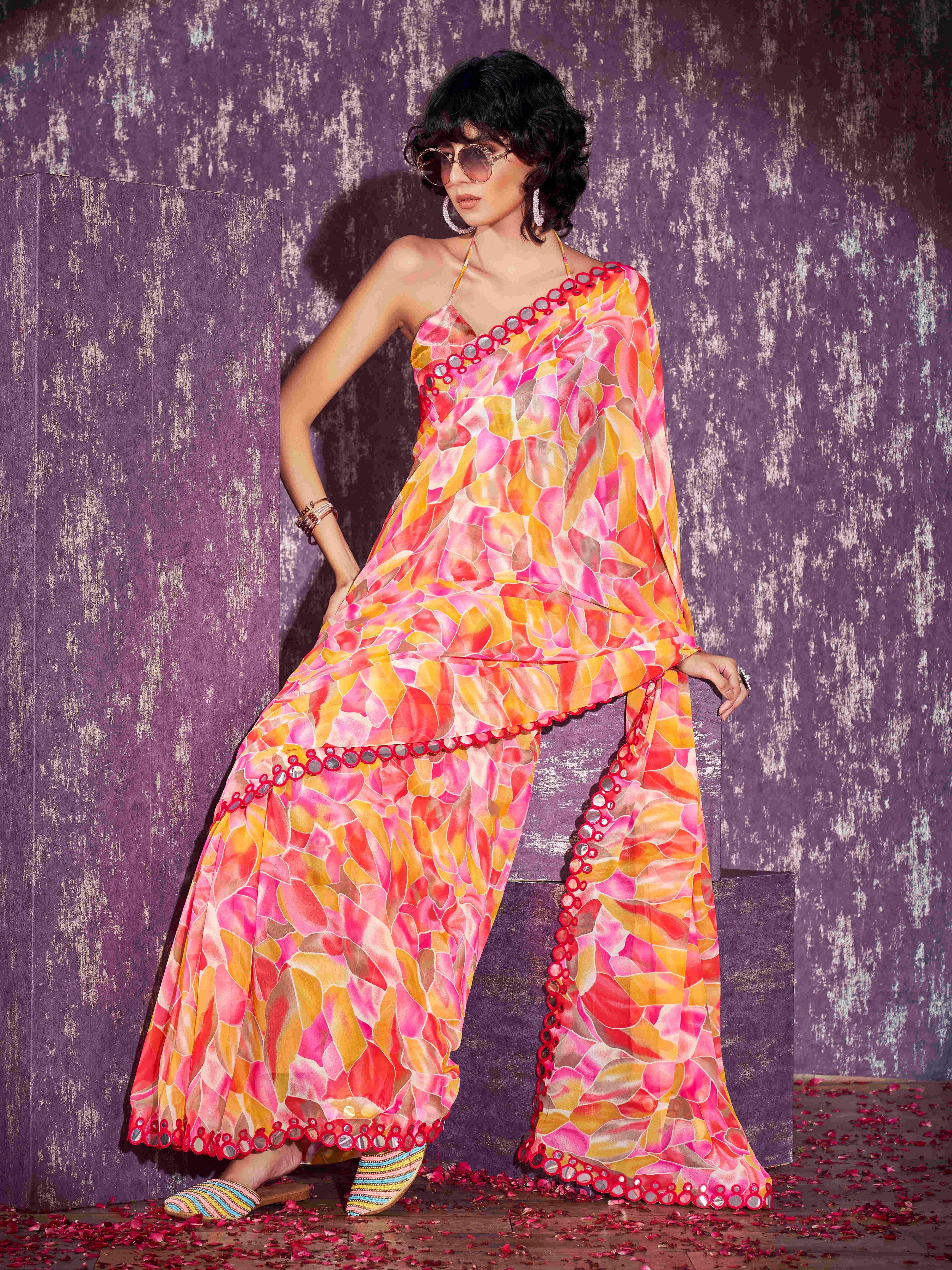 Pink and yellow colored georgette saree with faux mirror embroiderd scalloped lace