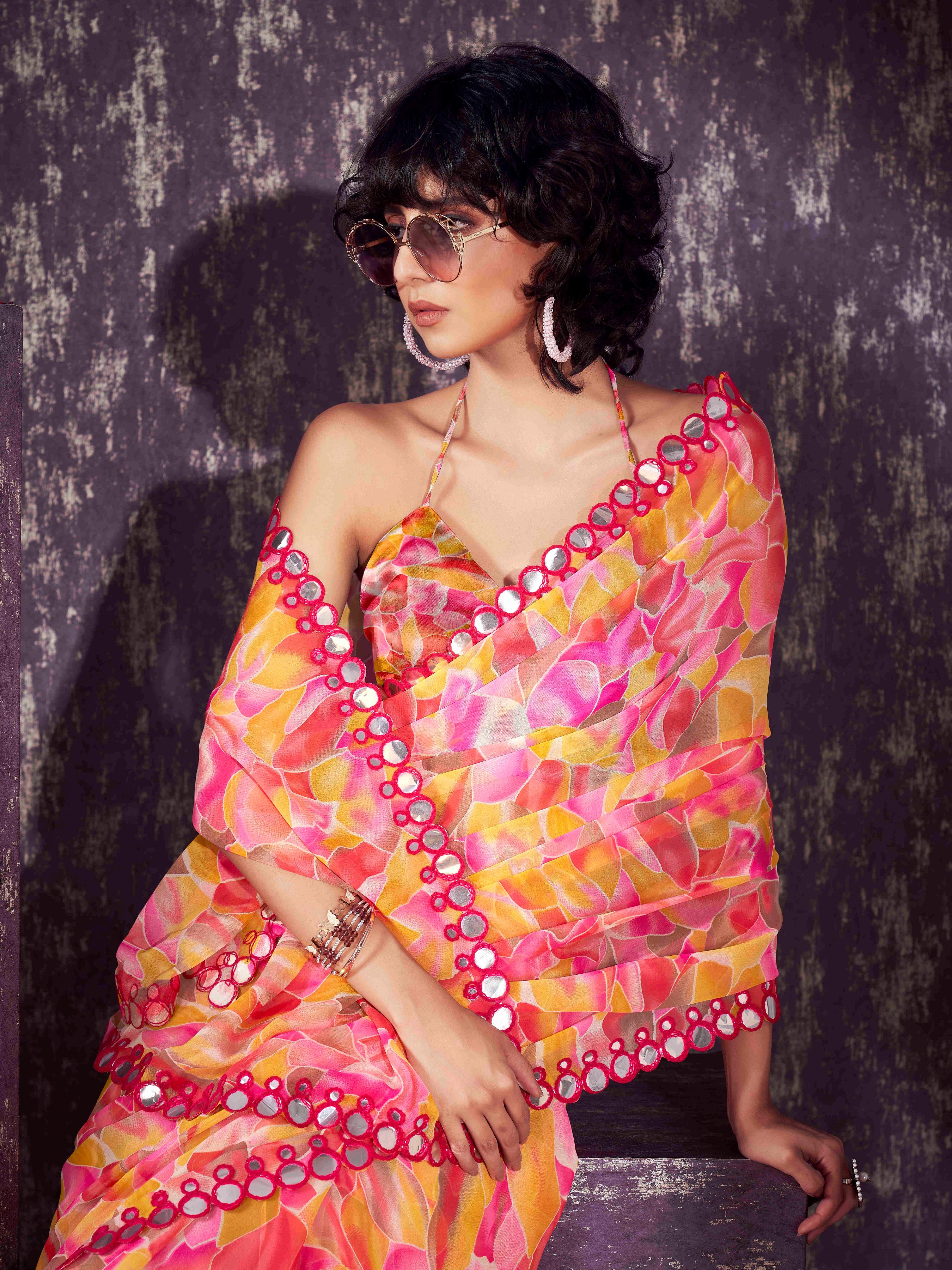 Pink and yellow colored georgette saree with faux mirror embroiderd scalloped lace