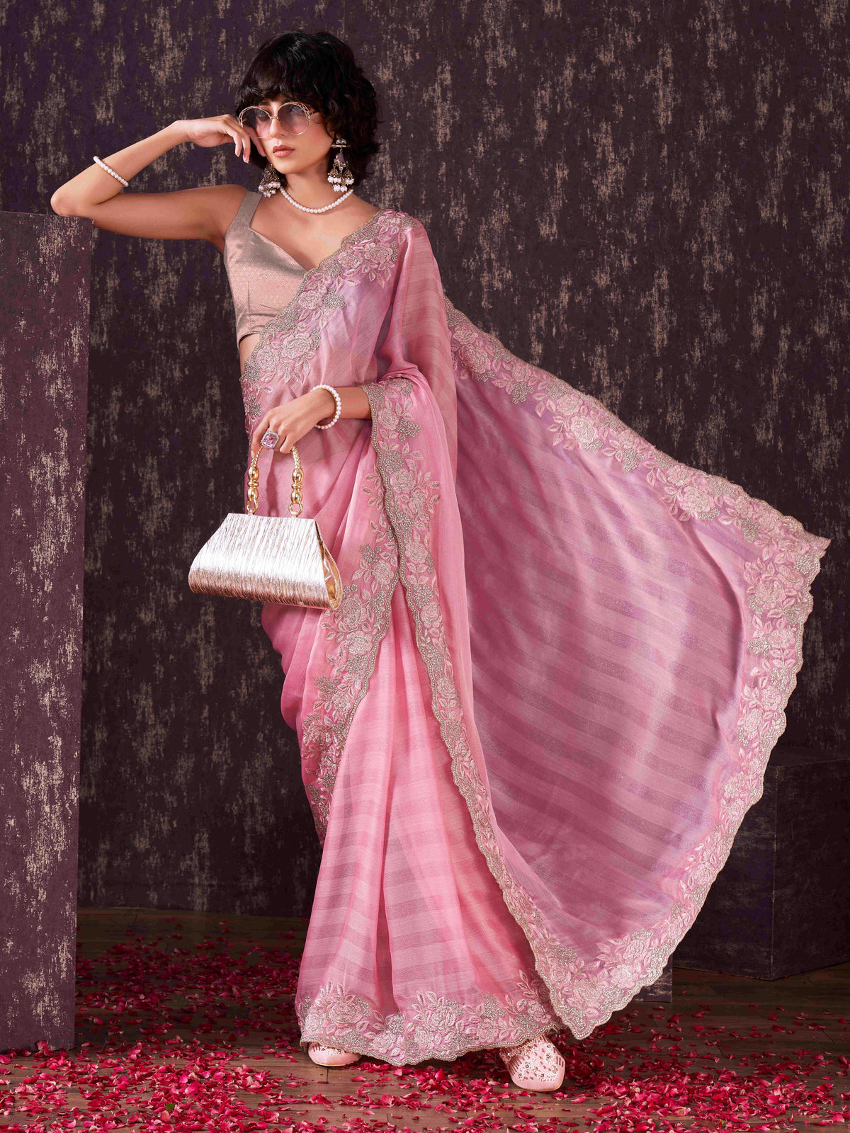 Pink colored striped embroidered saree with brocade blouse