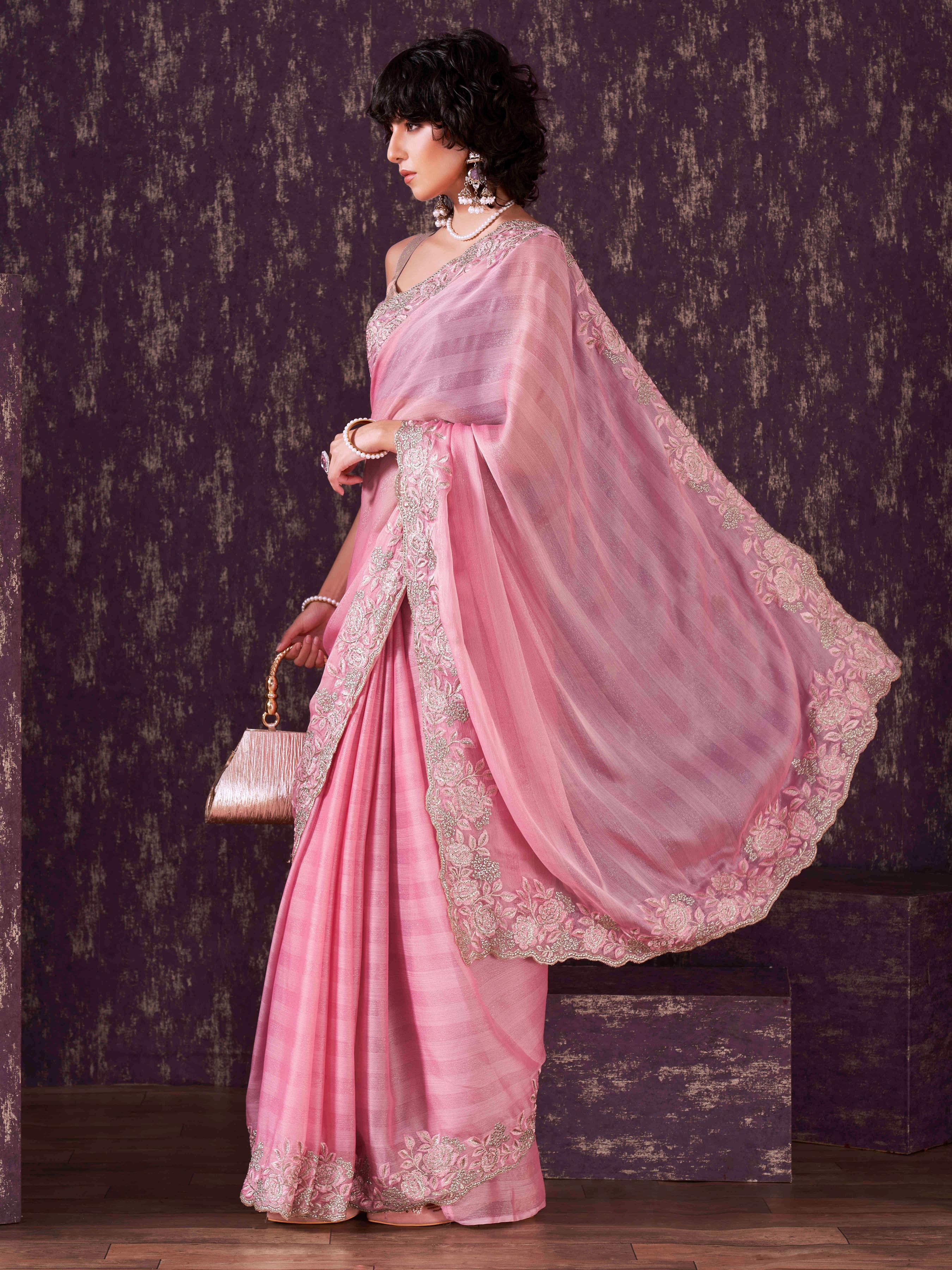 Pink colored striped embroidered saree with brocade blouse