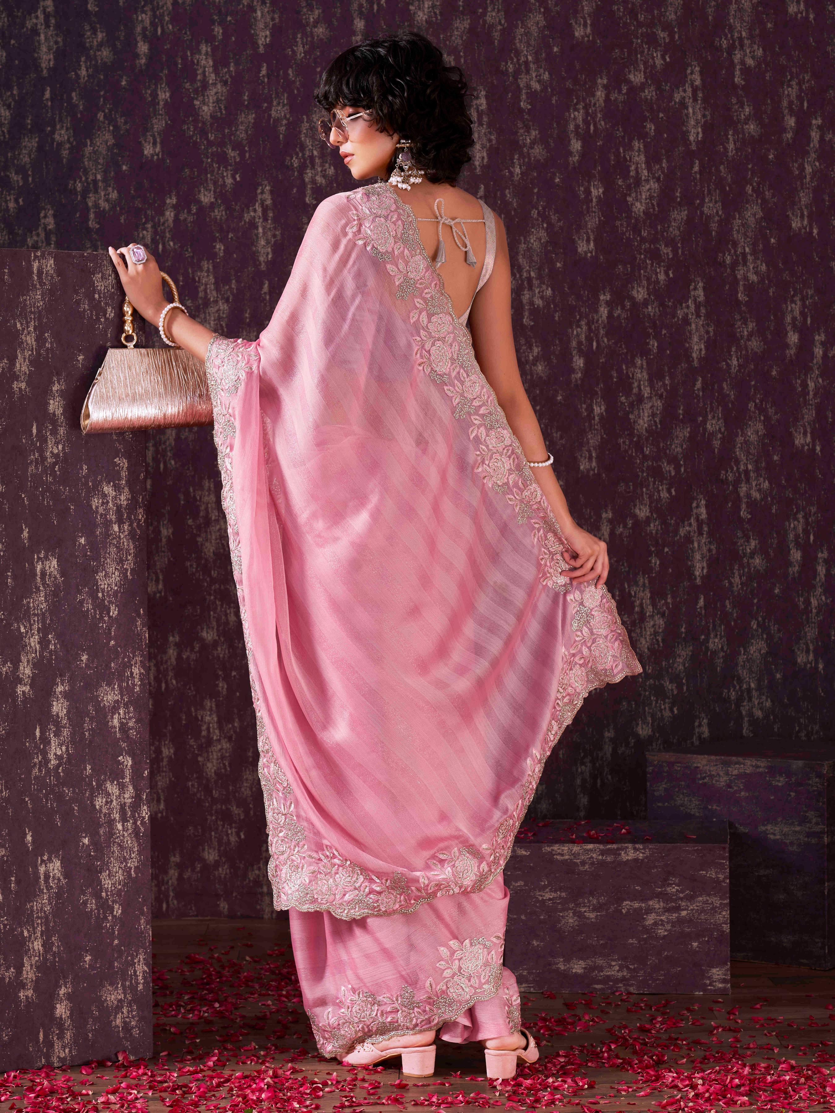 Pink colored striped embroidered saree with brocade blouse