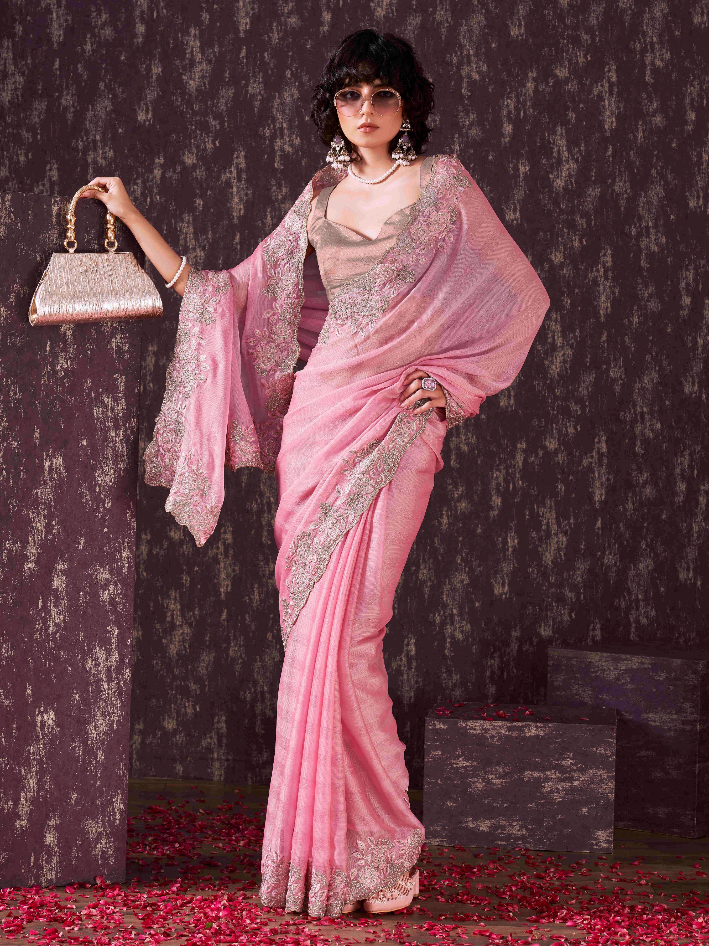 Pink colored striped embroidered saree with brocade blouse