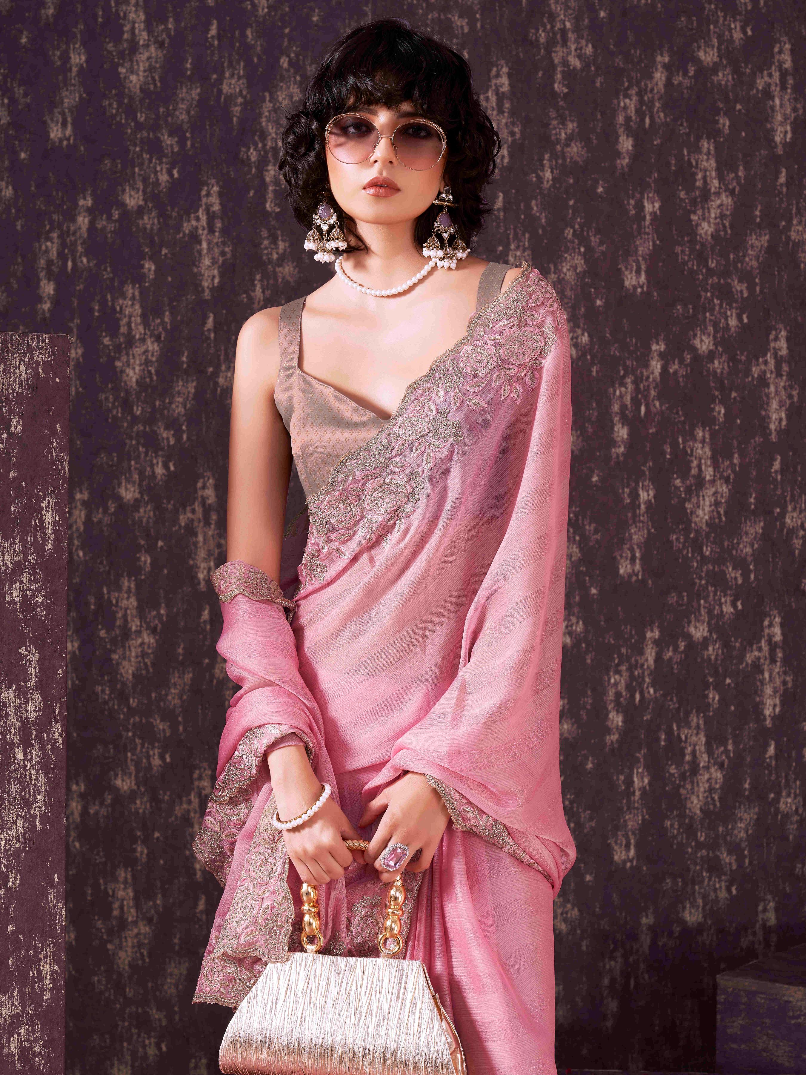 Pink colored striped embroidered saree with brocade blouse