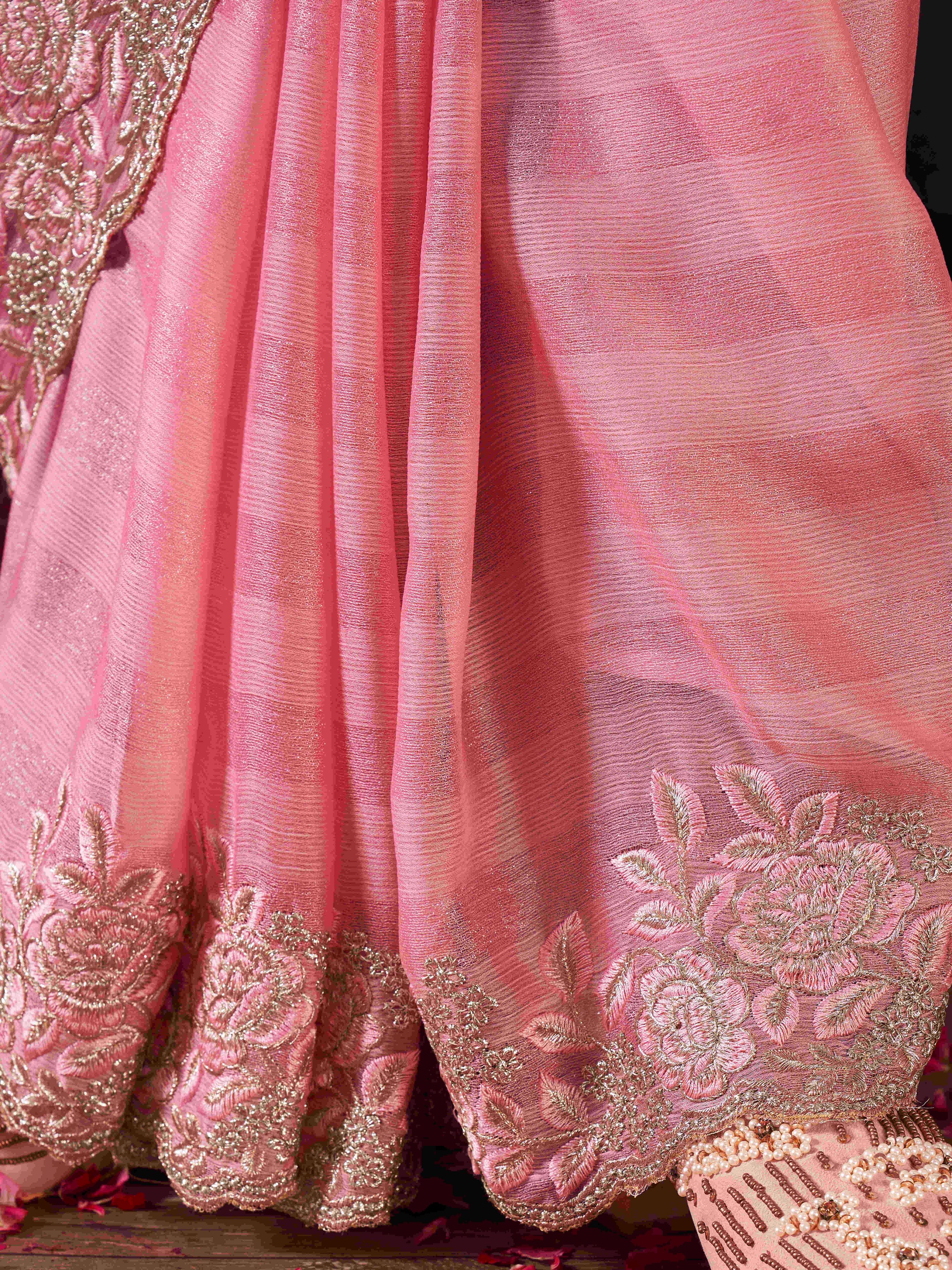 Pink colored striped embroidered saree with brocade blouse