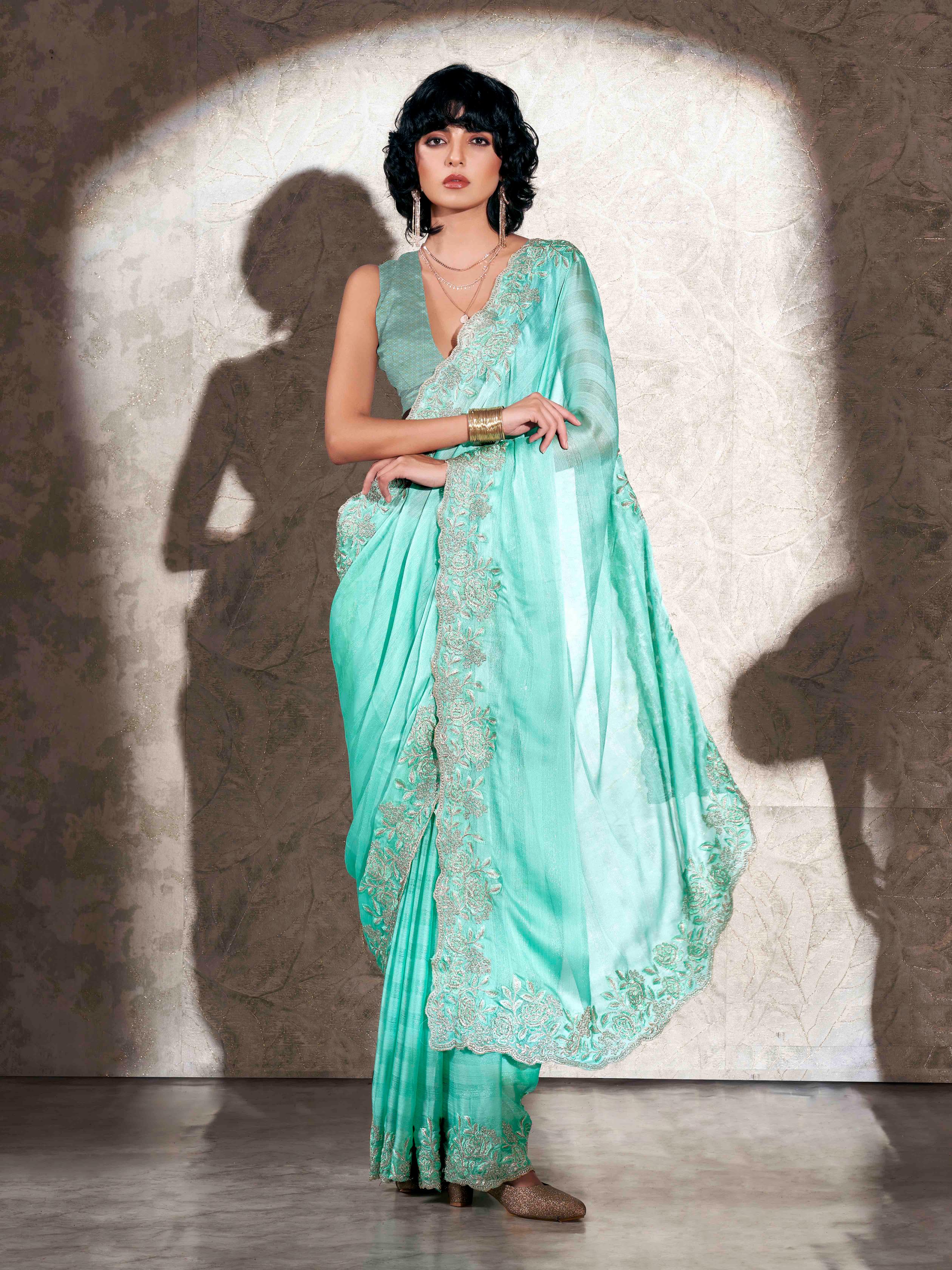 Sea green colored striped embroidered saree with brocade blouse