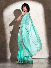 Sea green colored striped embroidered saree with brocade blouse