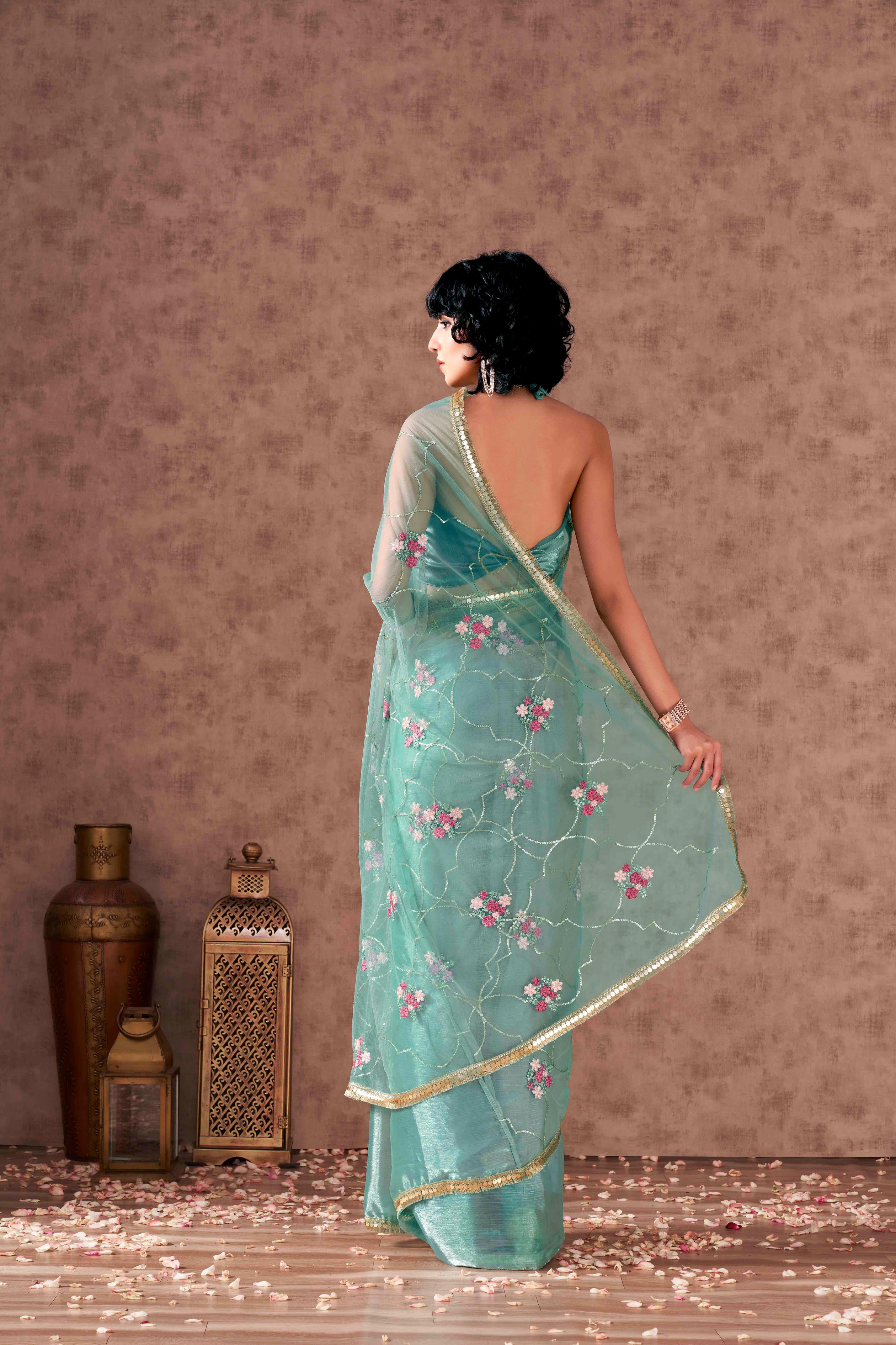 Half and half sea green colored net and satin chiffon sequined embroidered saree with designer lace