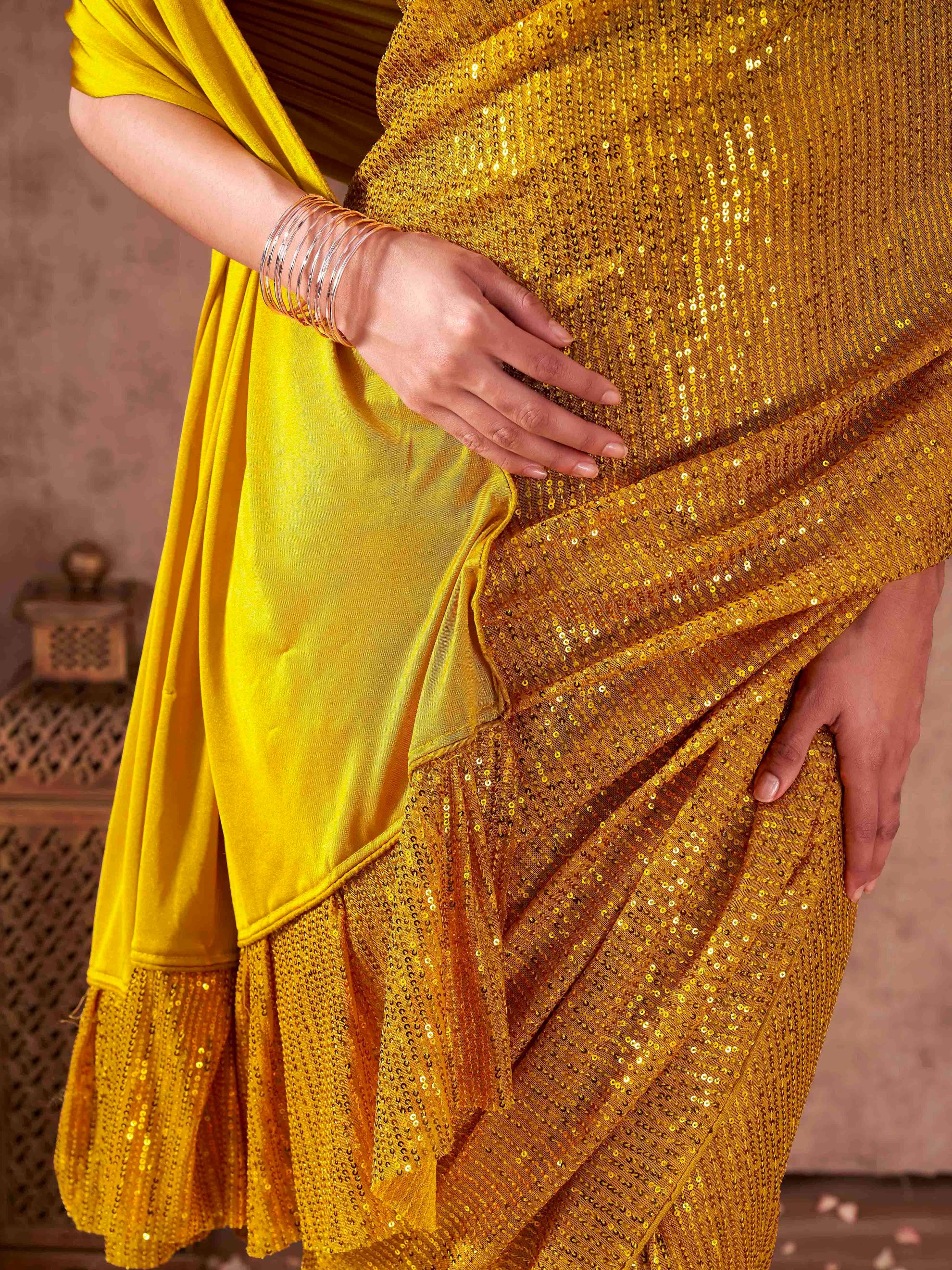 Half and Half yellow colored sequined lycra saree