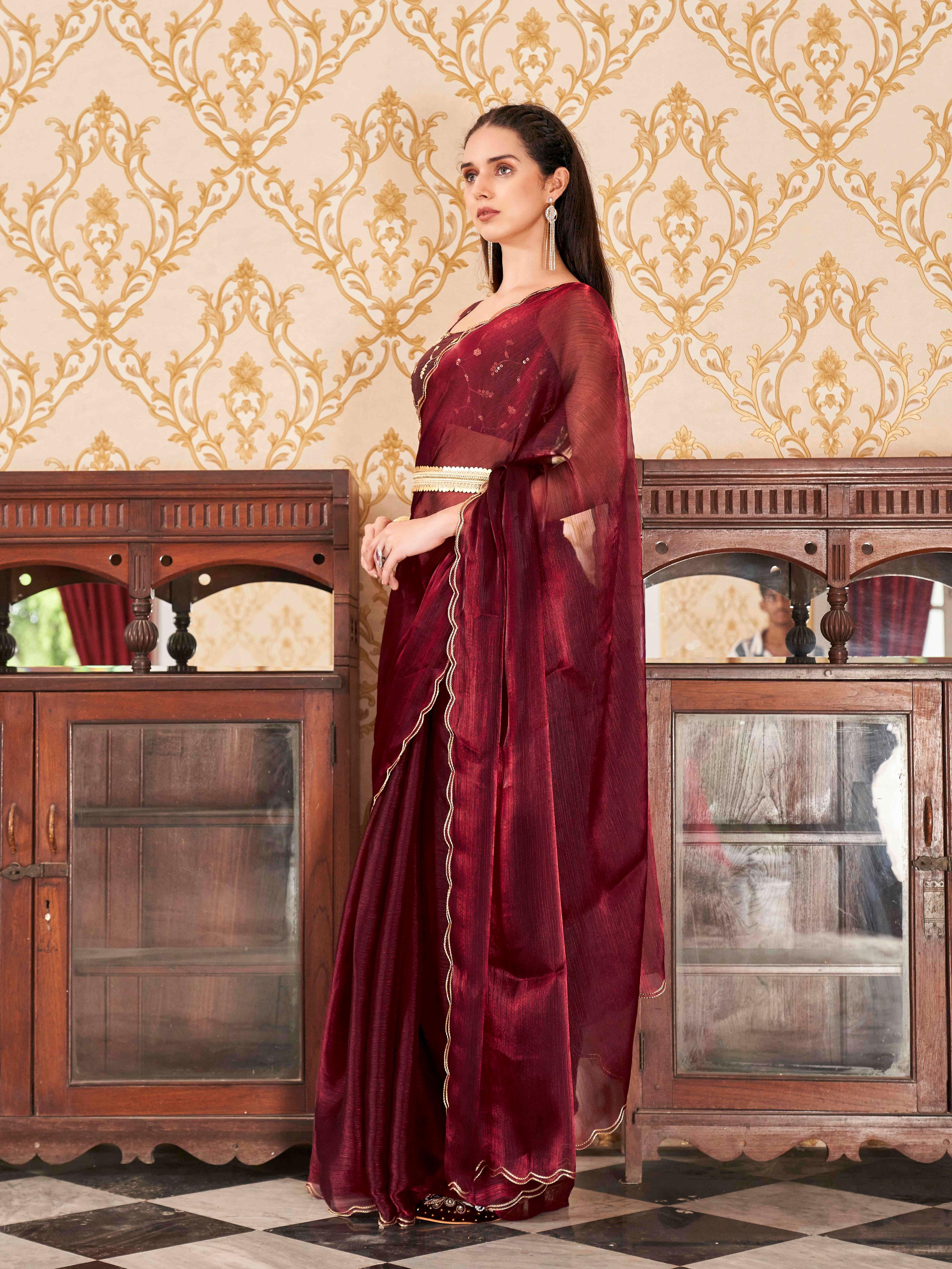 Maroon colored satin chiffon saree with embroiderd blouse and scalloped border