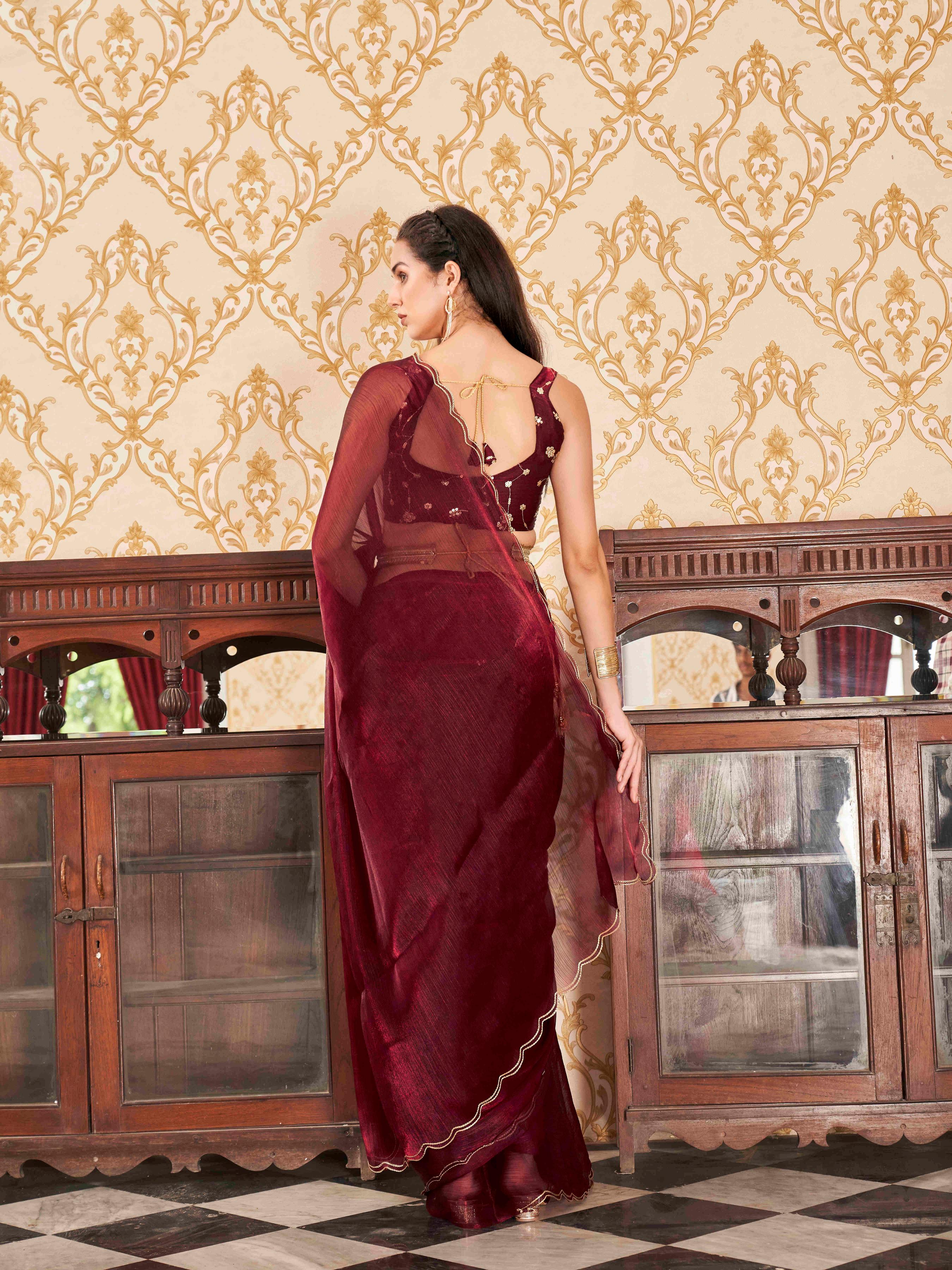 Maroon colored satin chiffon saree with embroiderd blouse and scalloped border