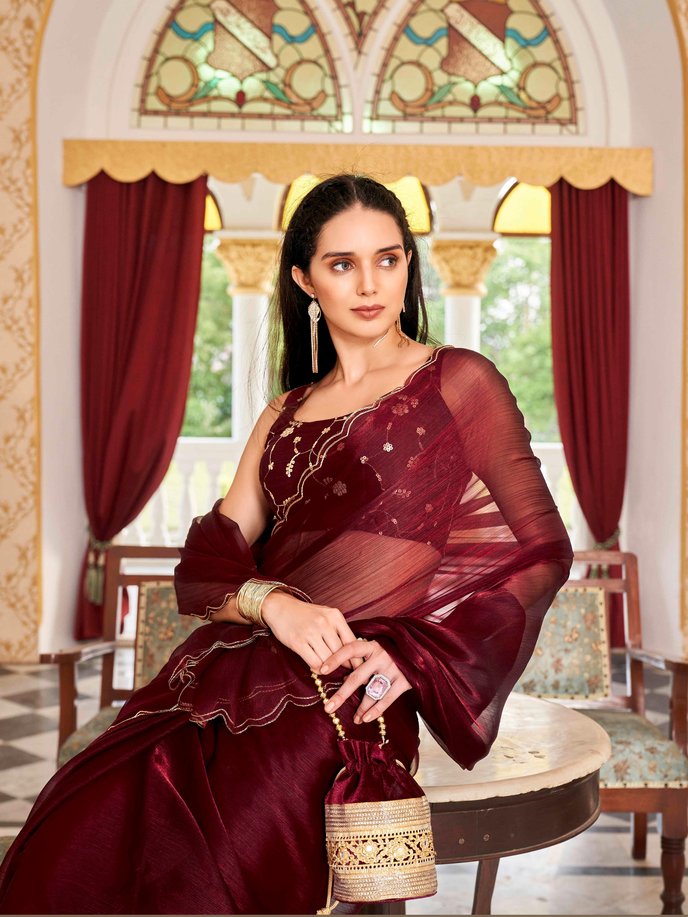 Maroon colored satin chiffon saree with embroiderd blouse and scalloped border