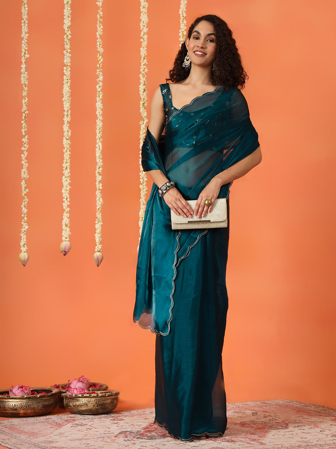 Teal colored satin chiffon saree with embroiderd blouse and scalloped border