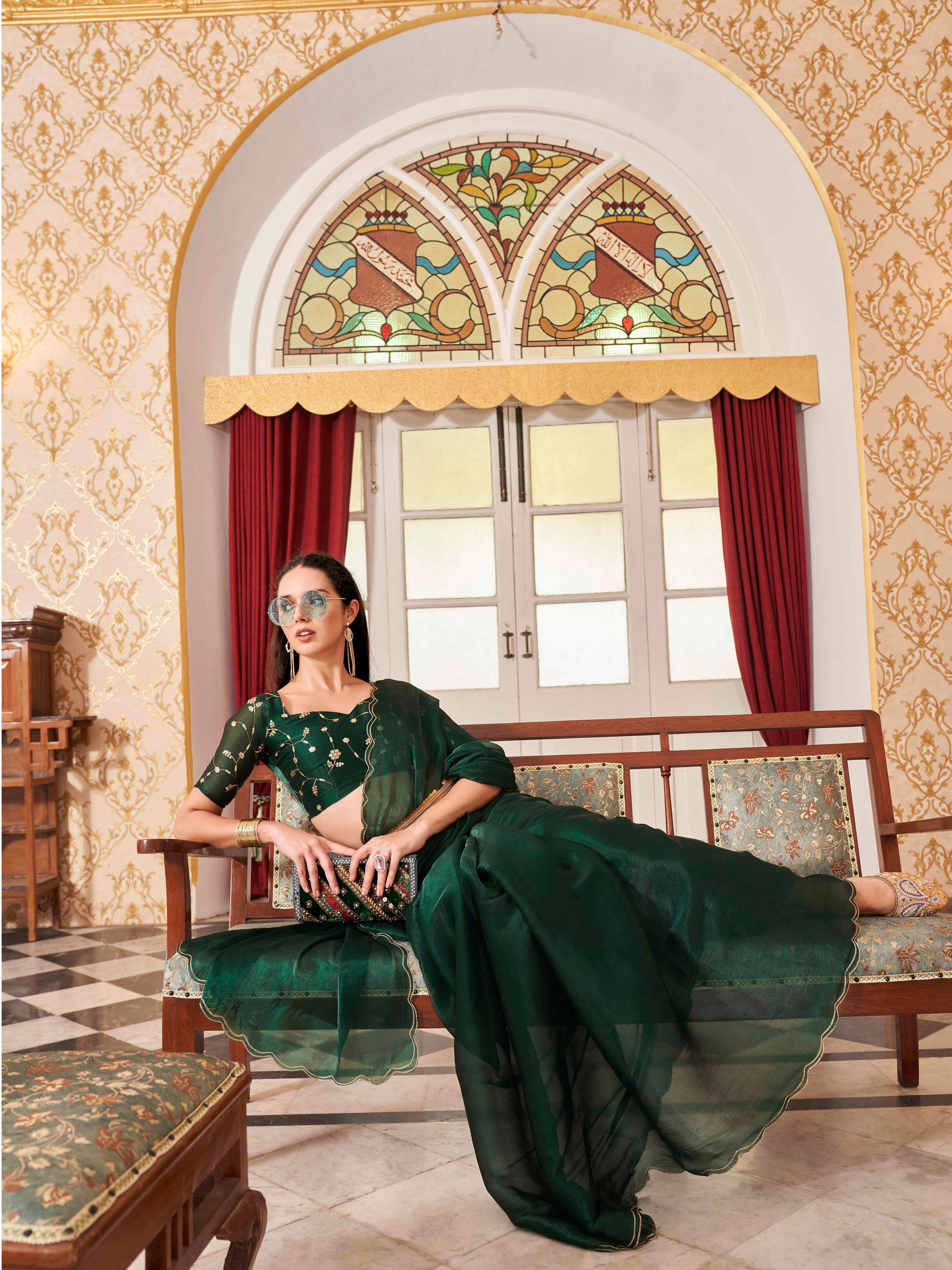 Bottle green colored satin chiffon saree with embroiderd blouse and scalloped border