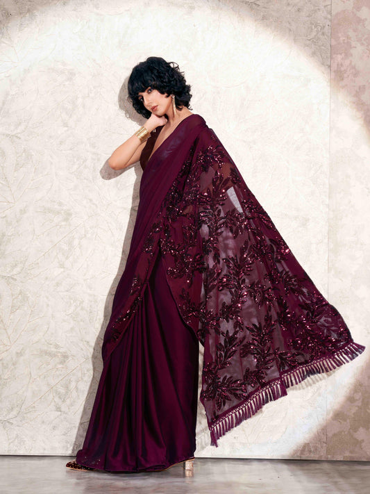 Burgundy colored designer sequence embroidered satin saree with tassles on pallu