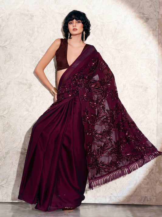 Burgundy colored designer sequence embroidered satin saree with tassles on pallu