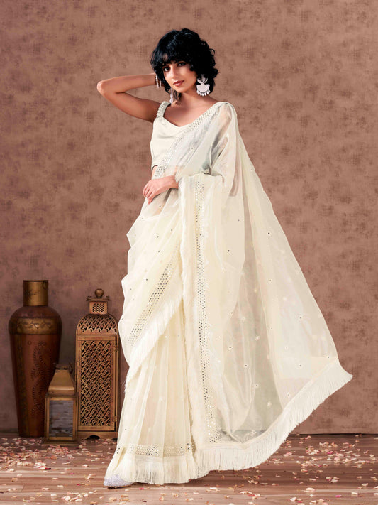 Off white colored supernet saree with faux mirror embroidery and tassles lace