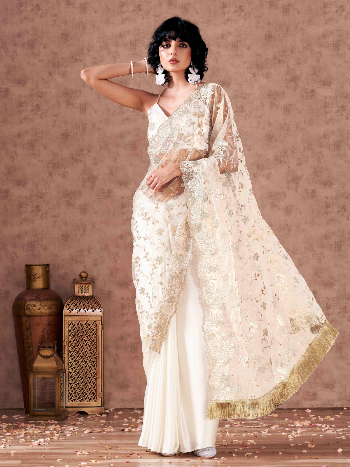 Off white colored net and satin half and half embroidered saree