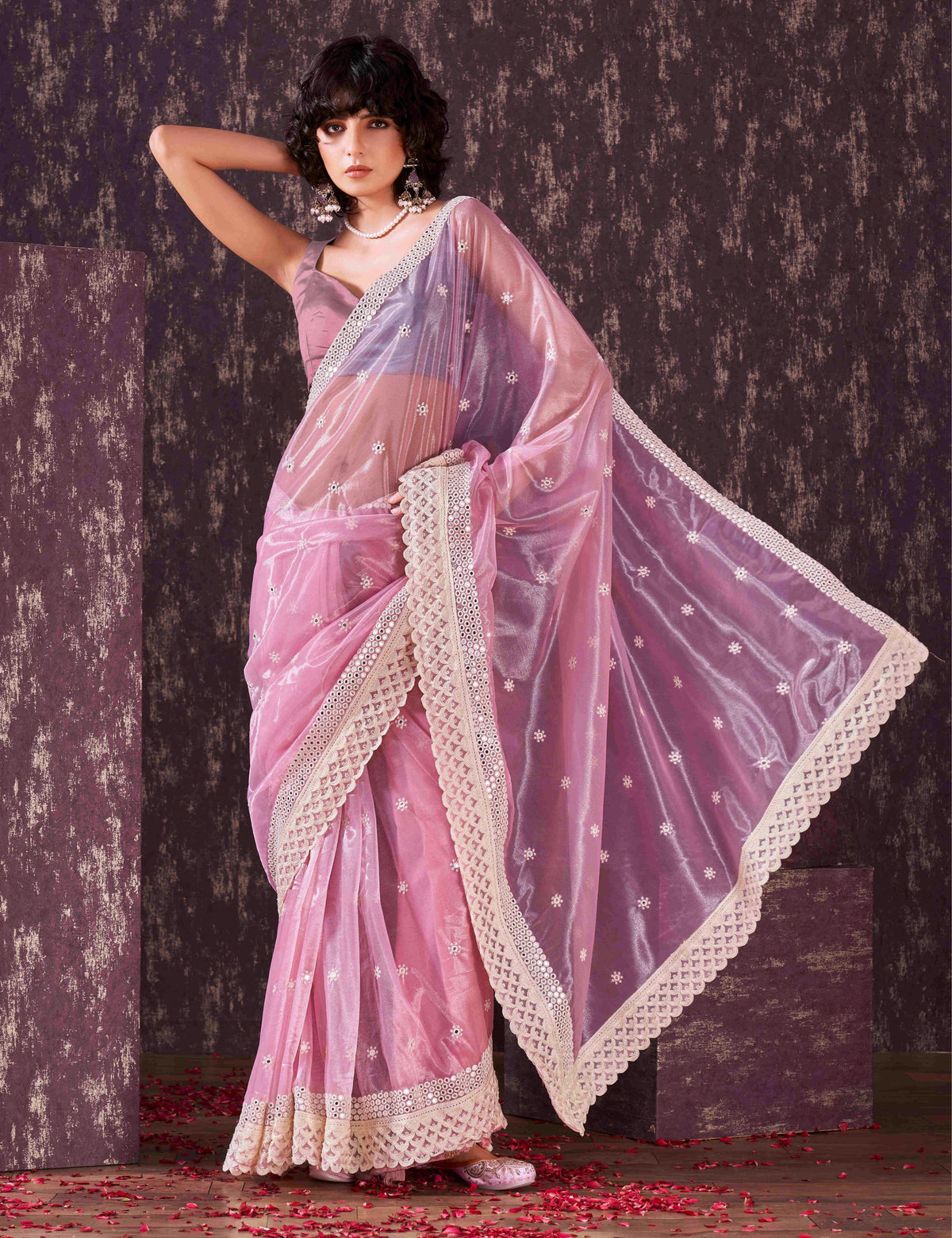 Pink colored supernet saree with faux mirror embroidery and crochet lace