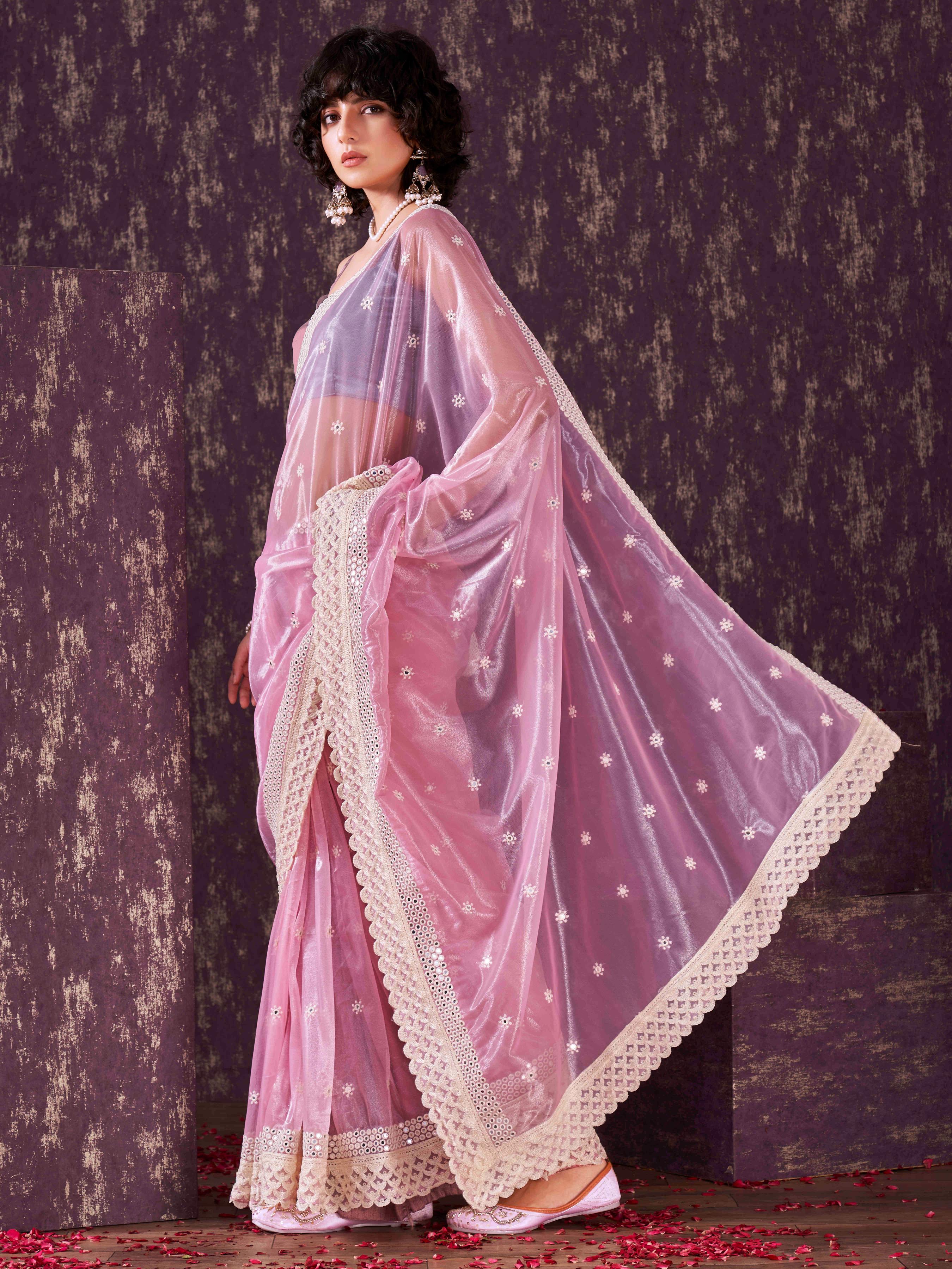 Pink colored supernet saree with faux mirror embroidery and crochet lace