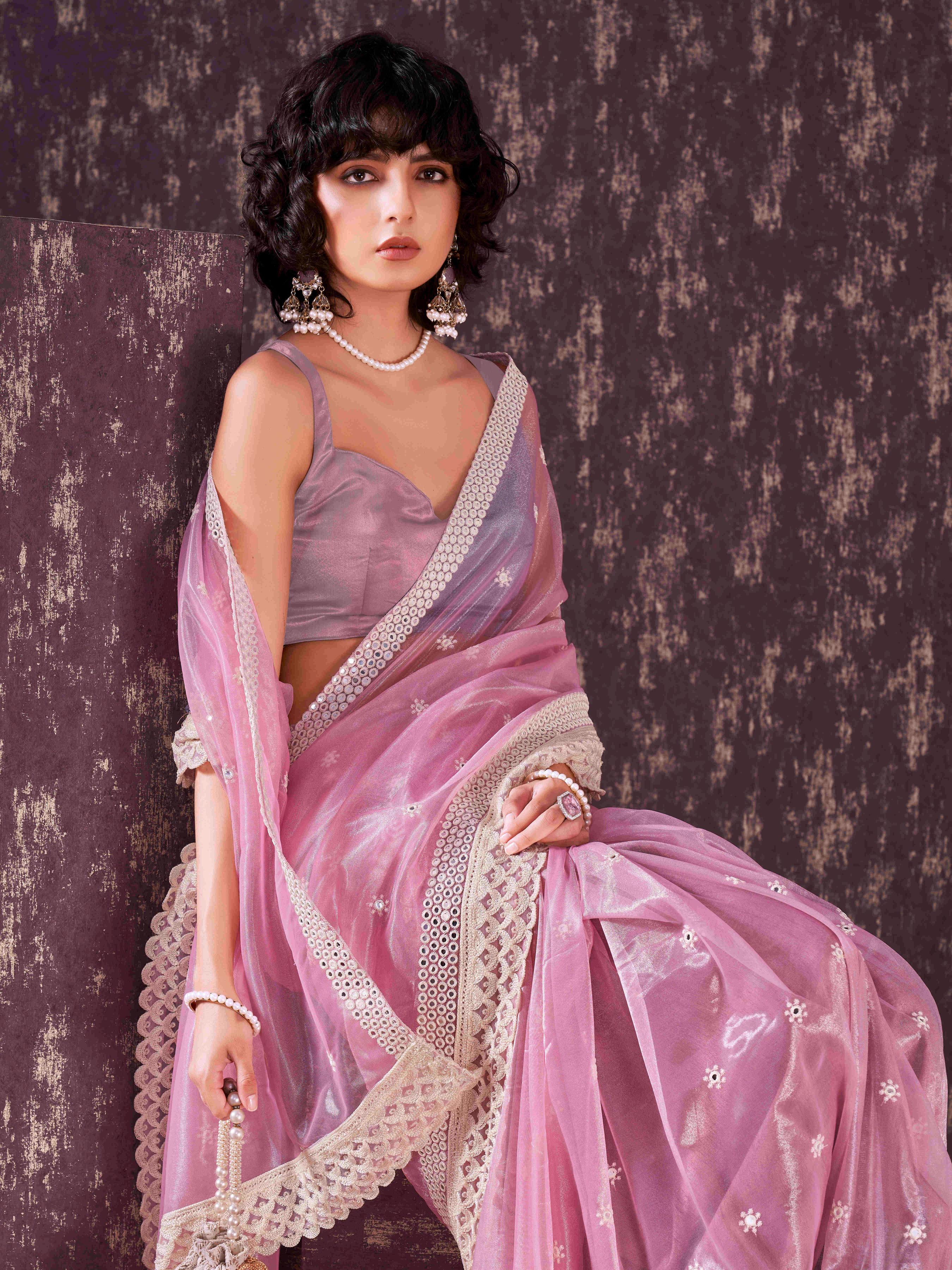 Pink colored supernet saree with faux mirror embroidery and crochet lace