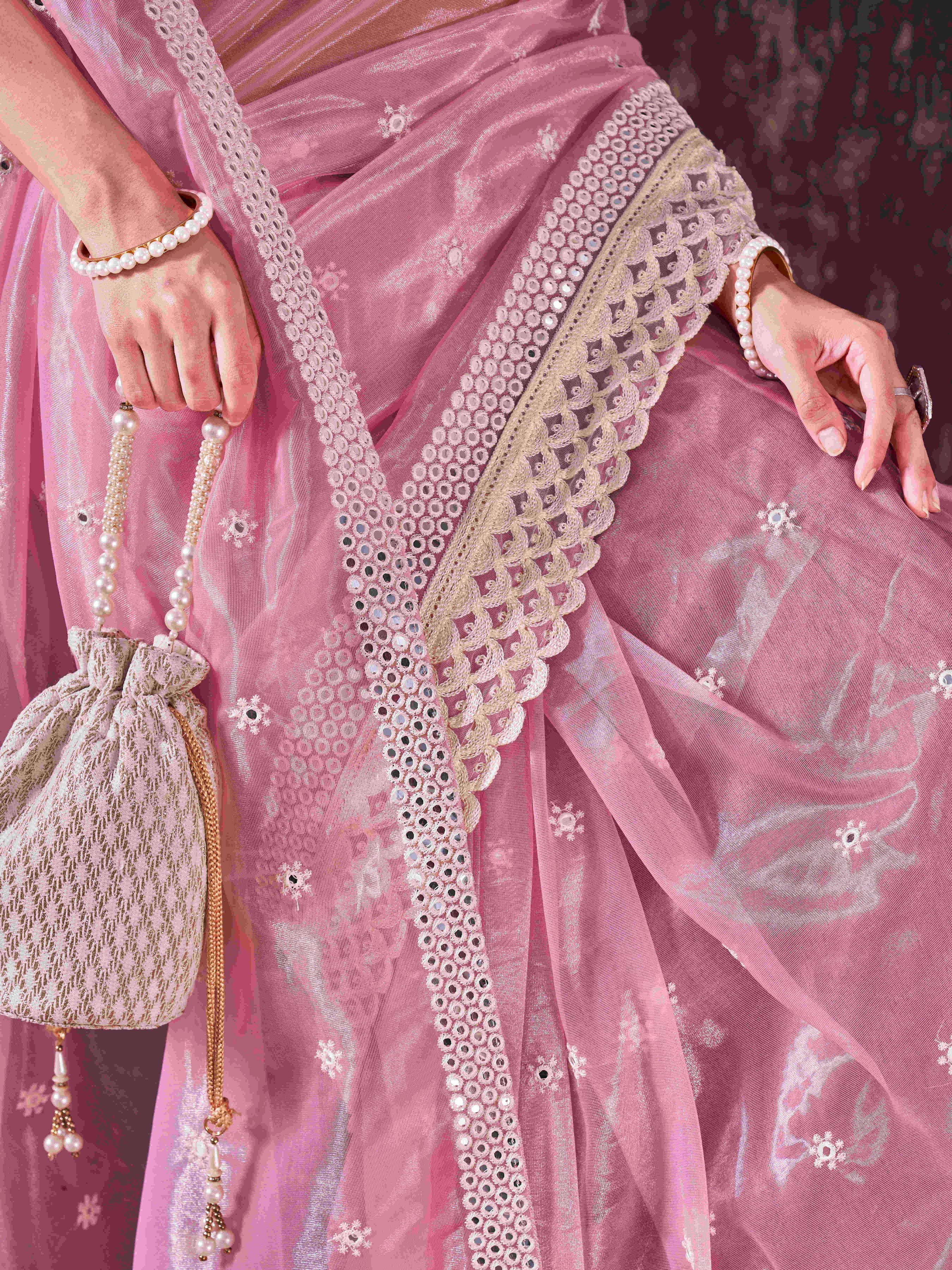 Pink colored supernet saree with faux mirror embroidery and crochet lace