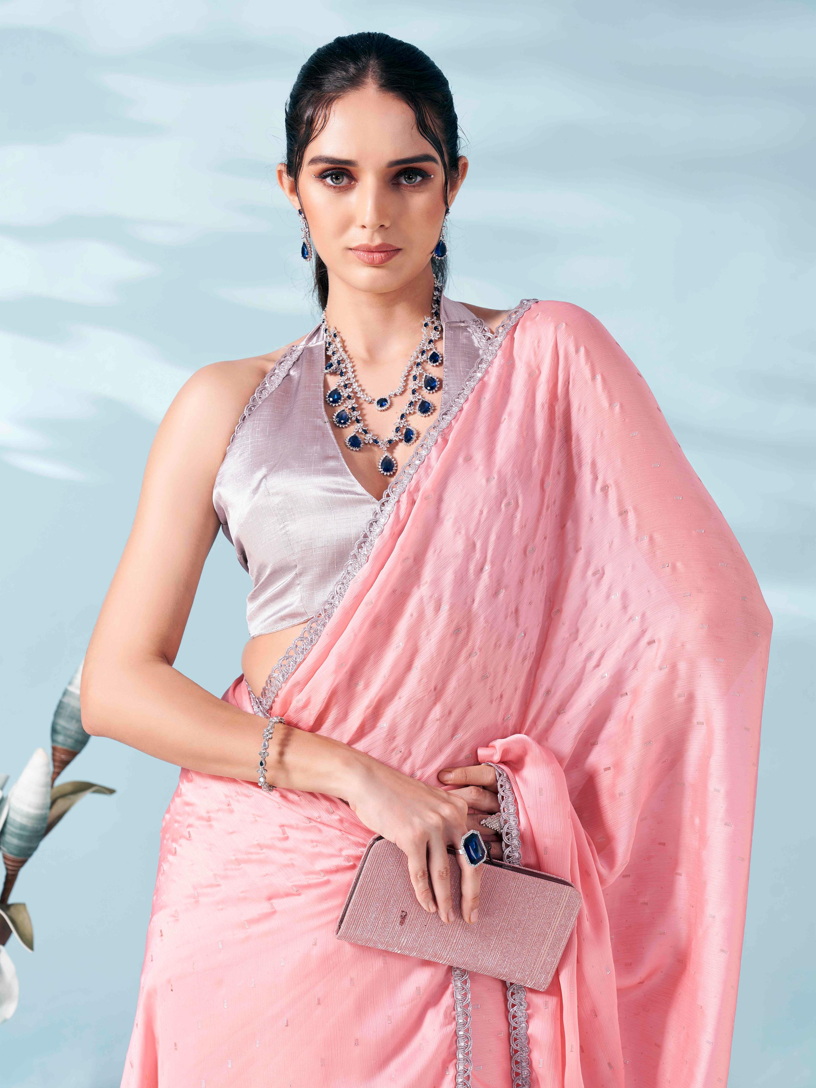 Peach colored satin foil printed saree with embellished lace