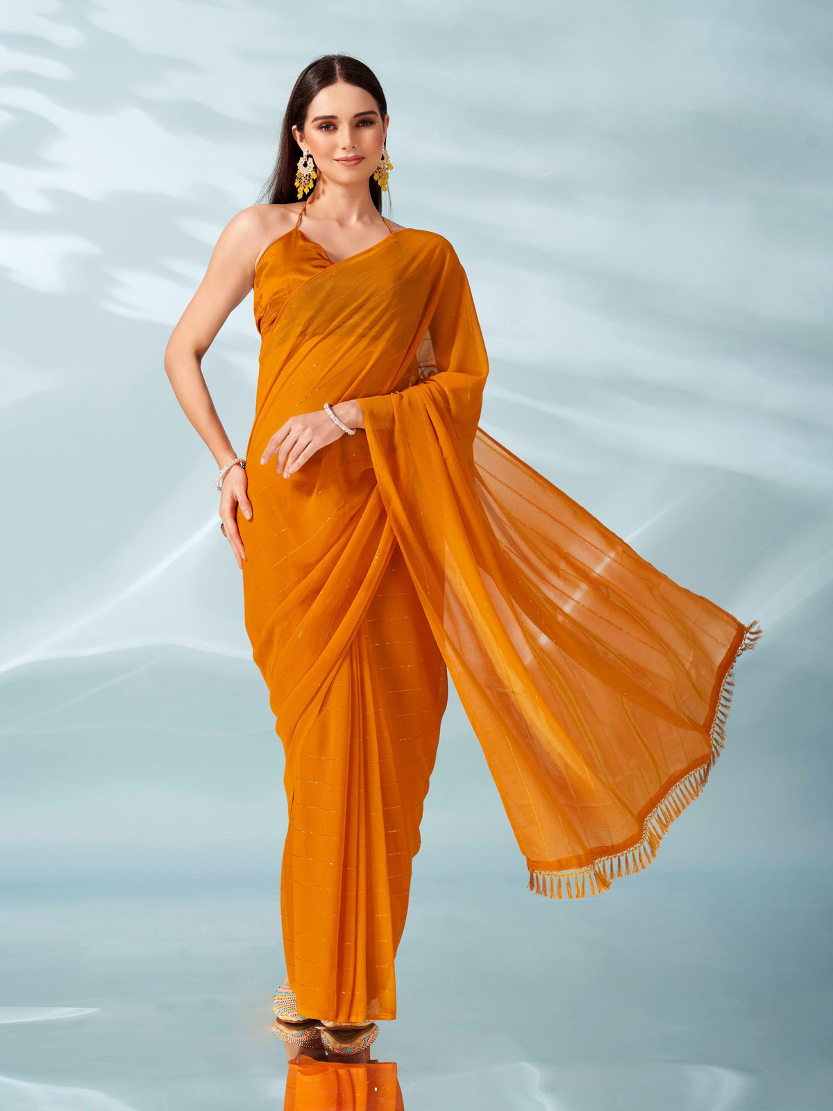 Yellow colored sequinned georgette saree with brocade blouse