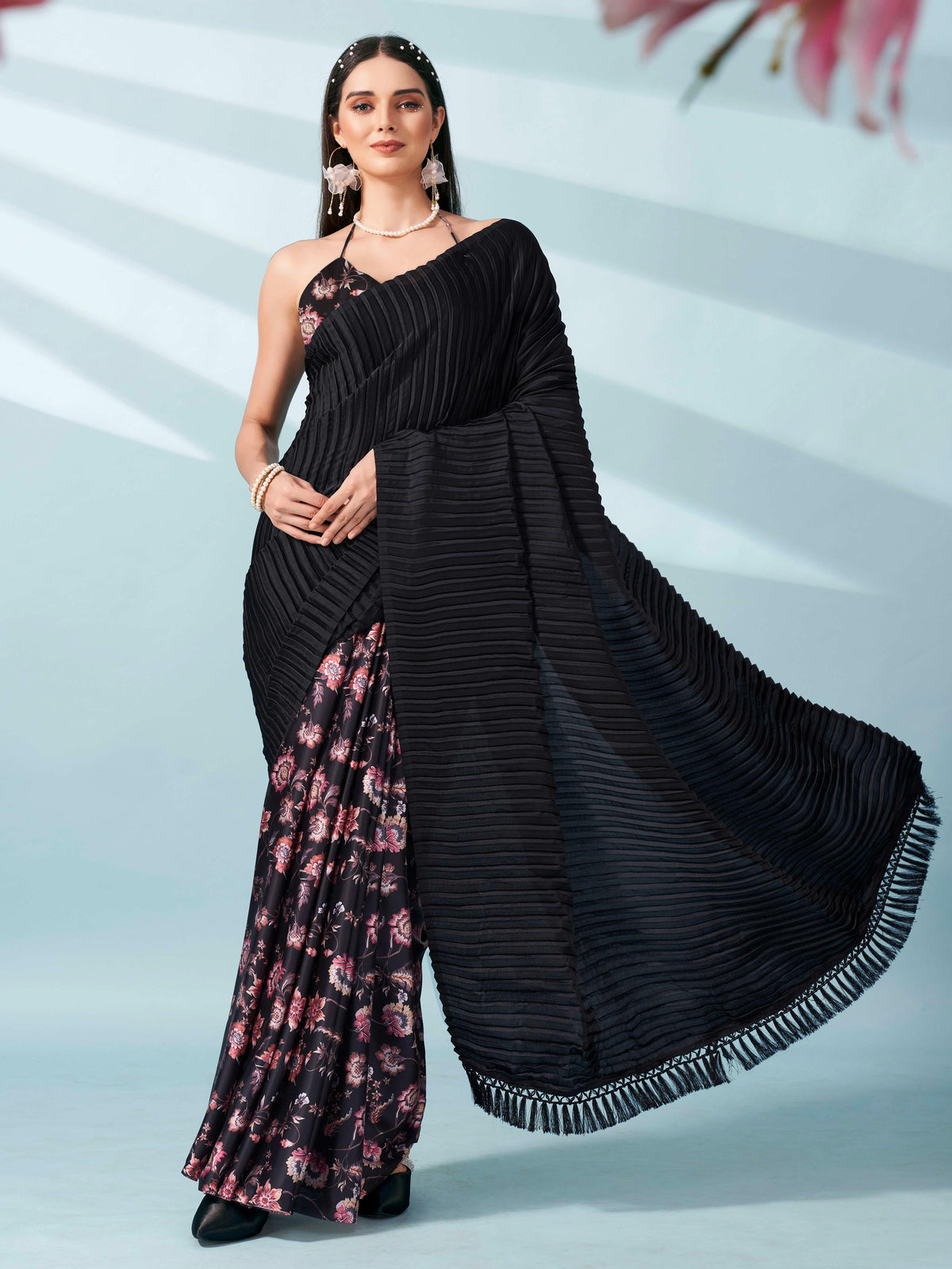 Black colored digital floral print half and half crepe saree with tassle in pallu