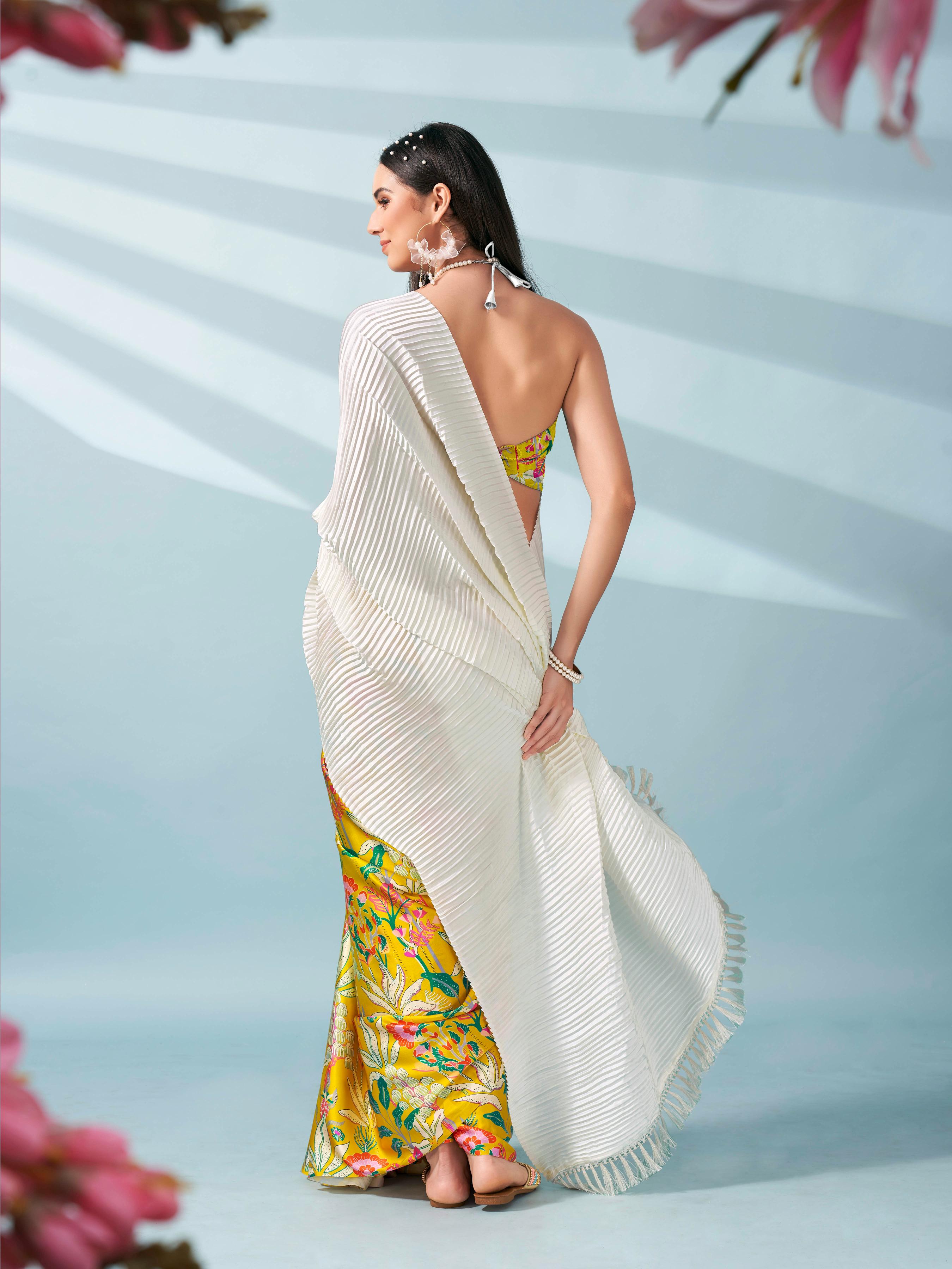 Cream and yellow colored digital floral print half and half crepe saree with tassle in pallu