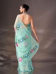 Sea green colored shimmer chiffon saree with hand print and scalloped border