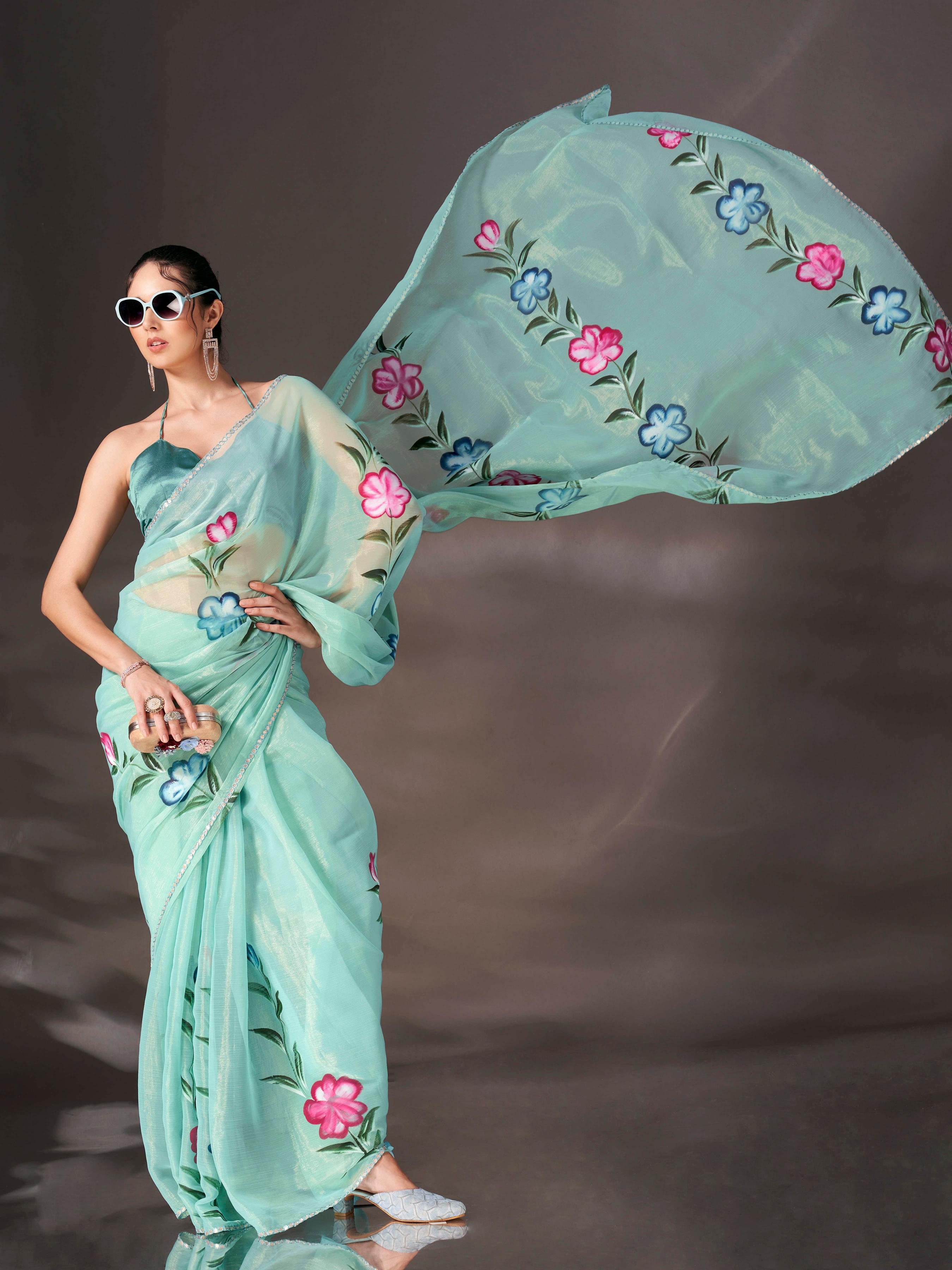 Sea green colored shimmer chiffon saree with hand print and scalloped border