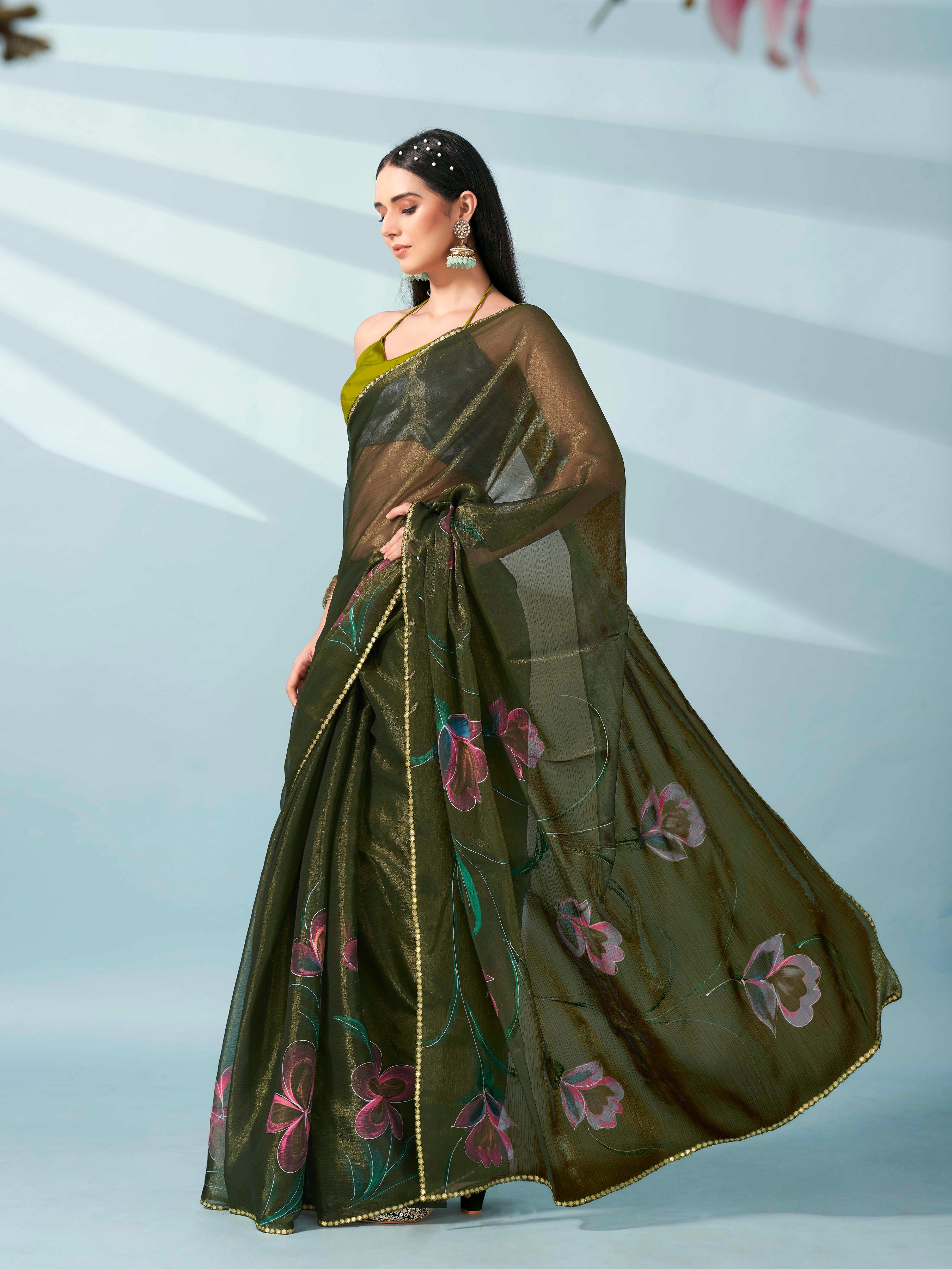 Green colored shimmer chiffon saree with hand print and scalloped border