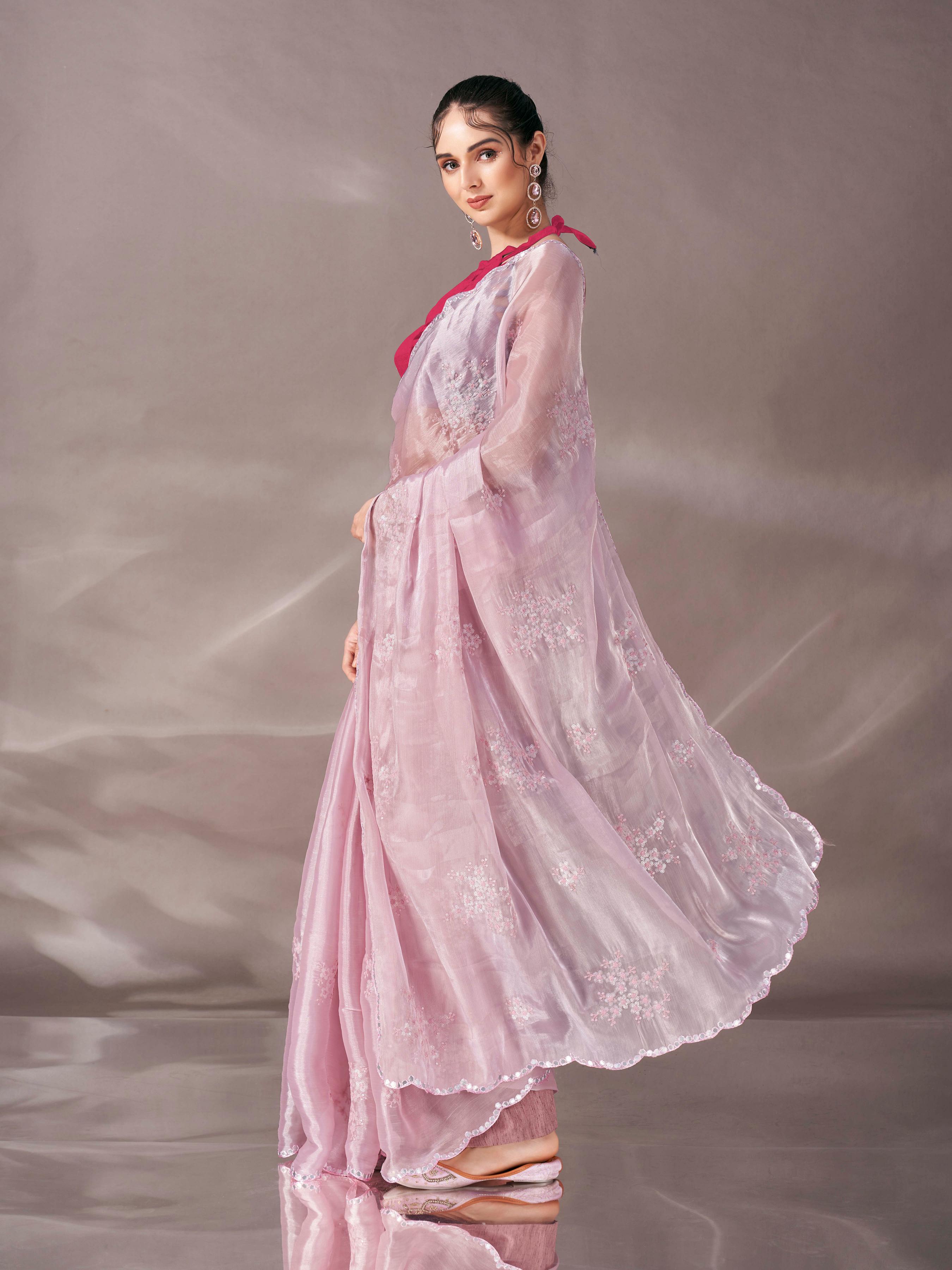 Baby pink colored shimmer satin saree with sequence embroidery and scalloped border