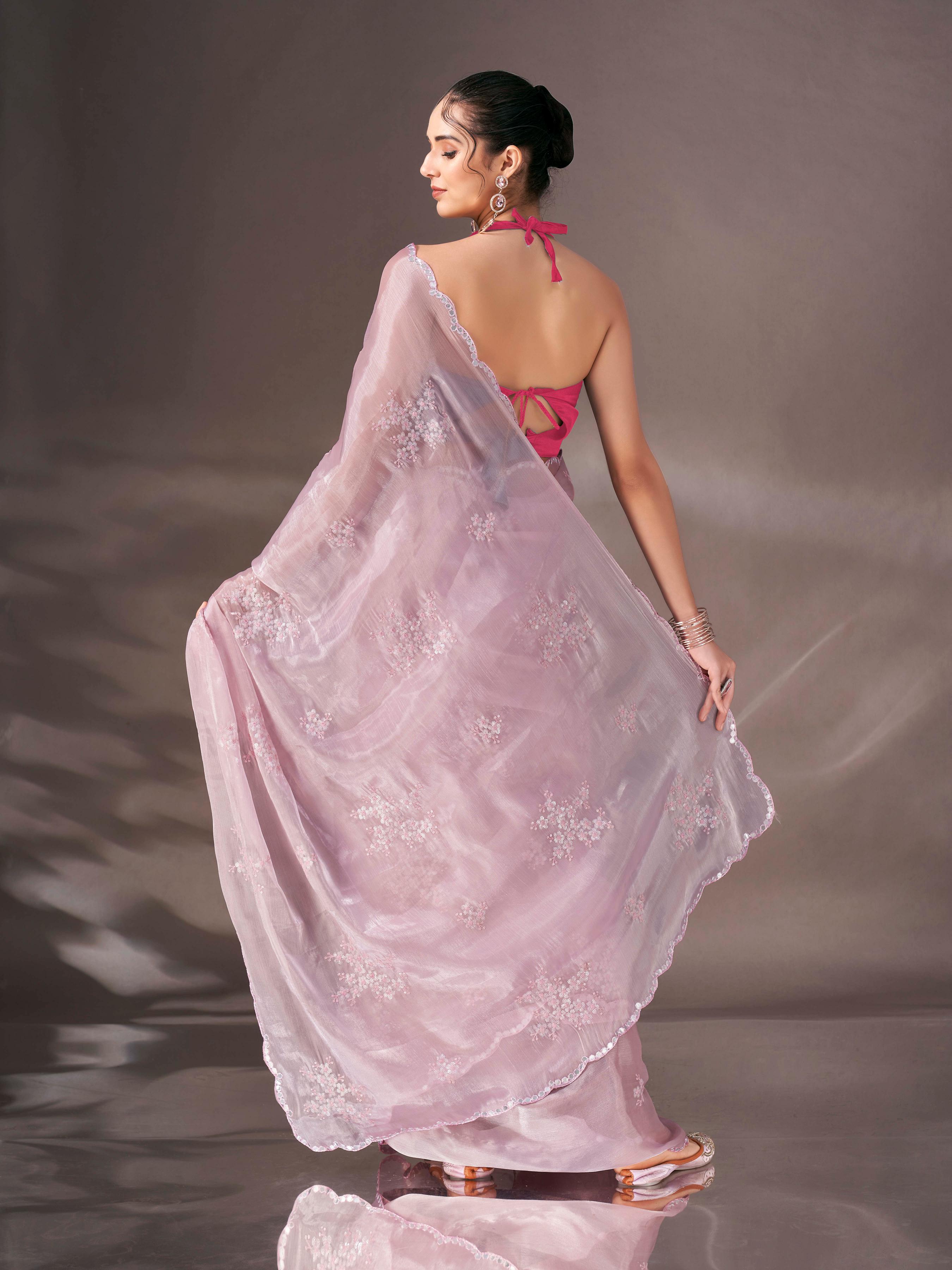 Baby pink colored shimmer satin saree with sequence embroidery and scalloped border