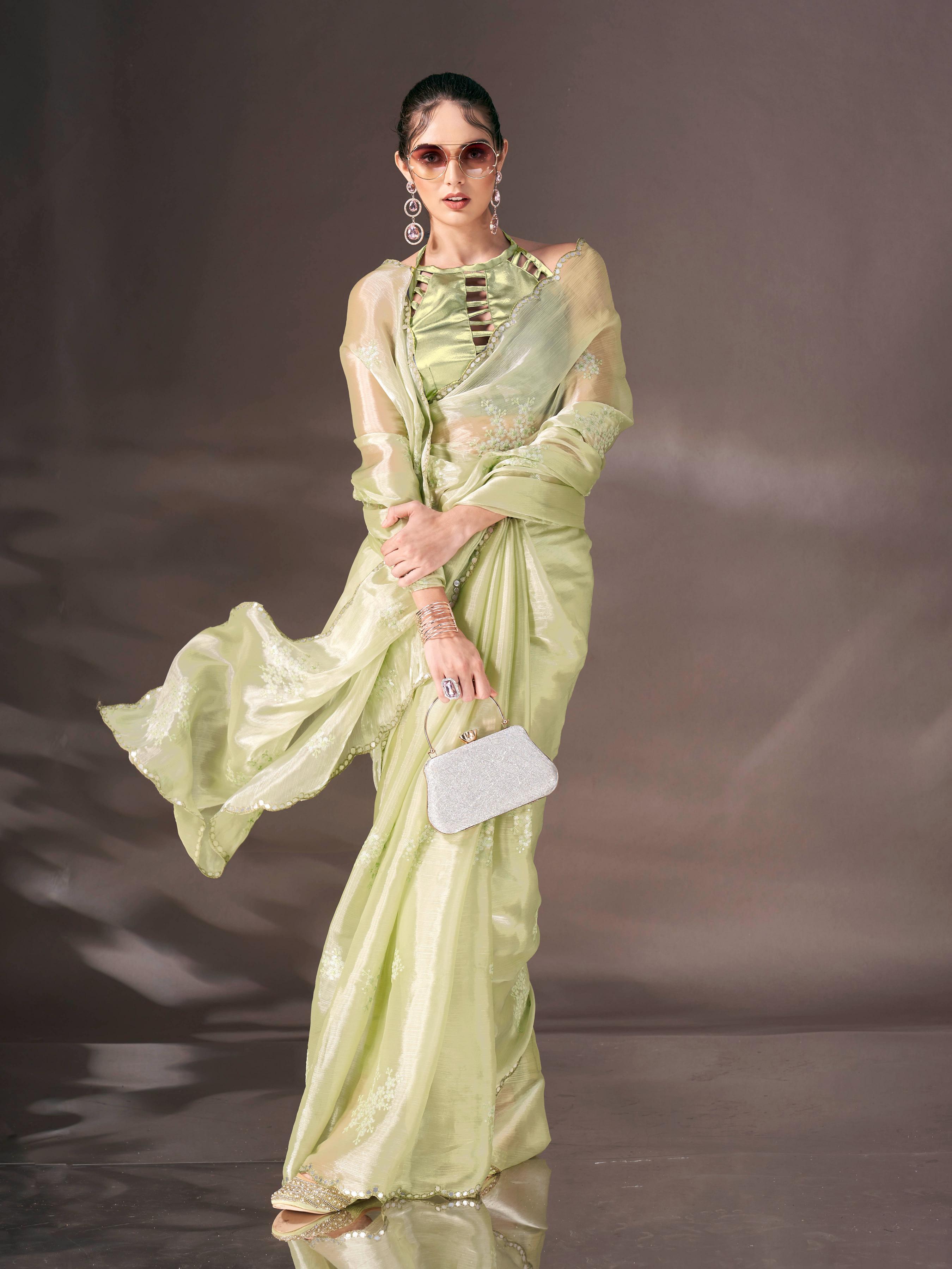 Pista green colored shimmer satin saree with sequence embroidery and scalloped border