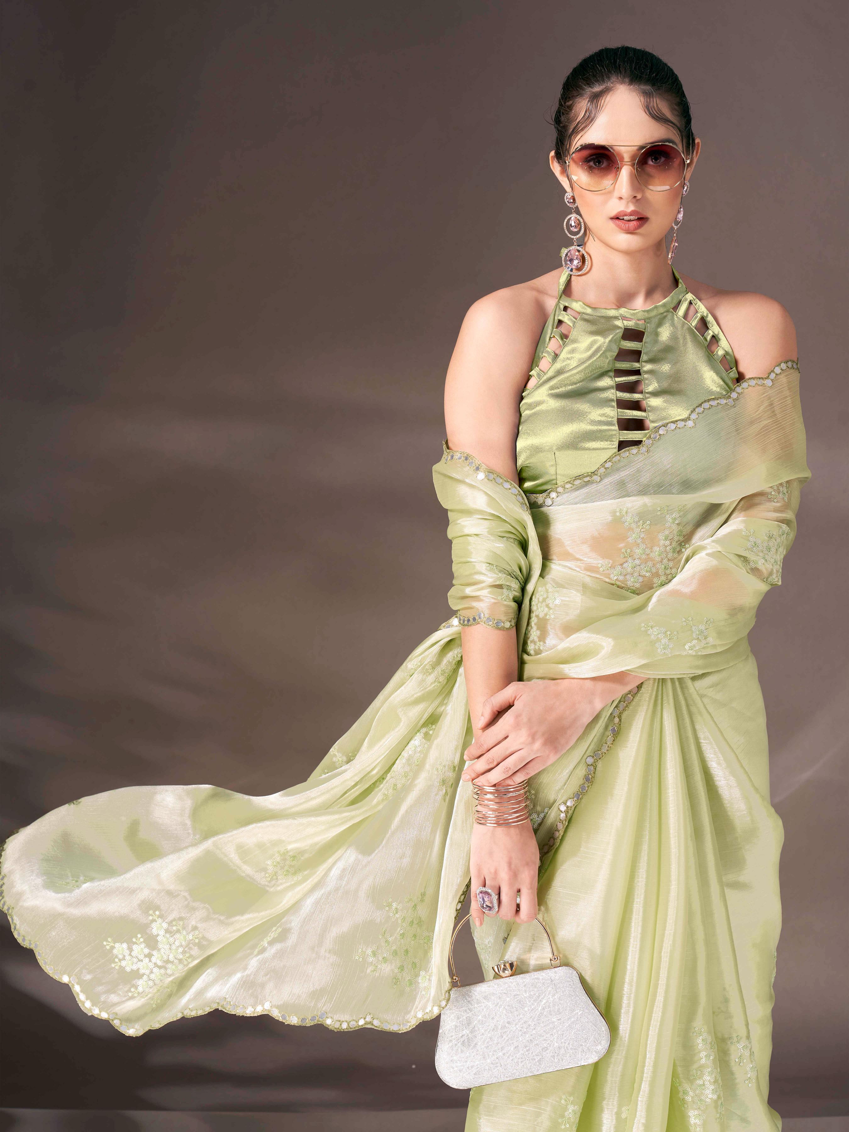 Pista green colored shimmer satin saree with sequence embroidery and scalloped border