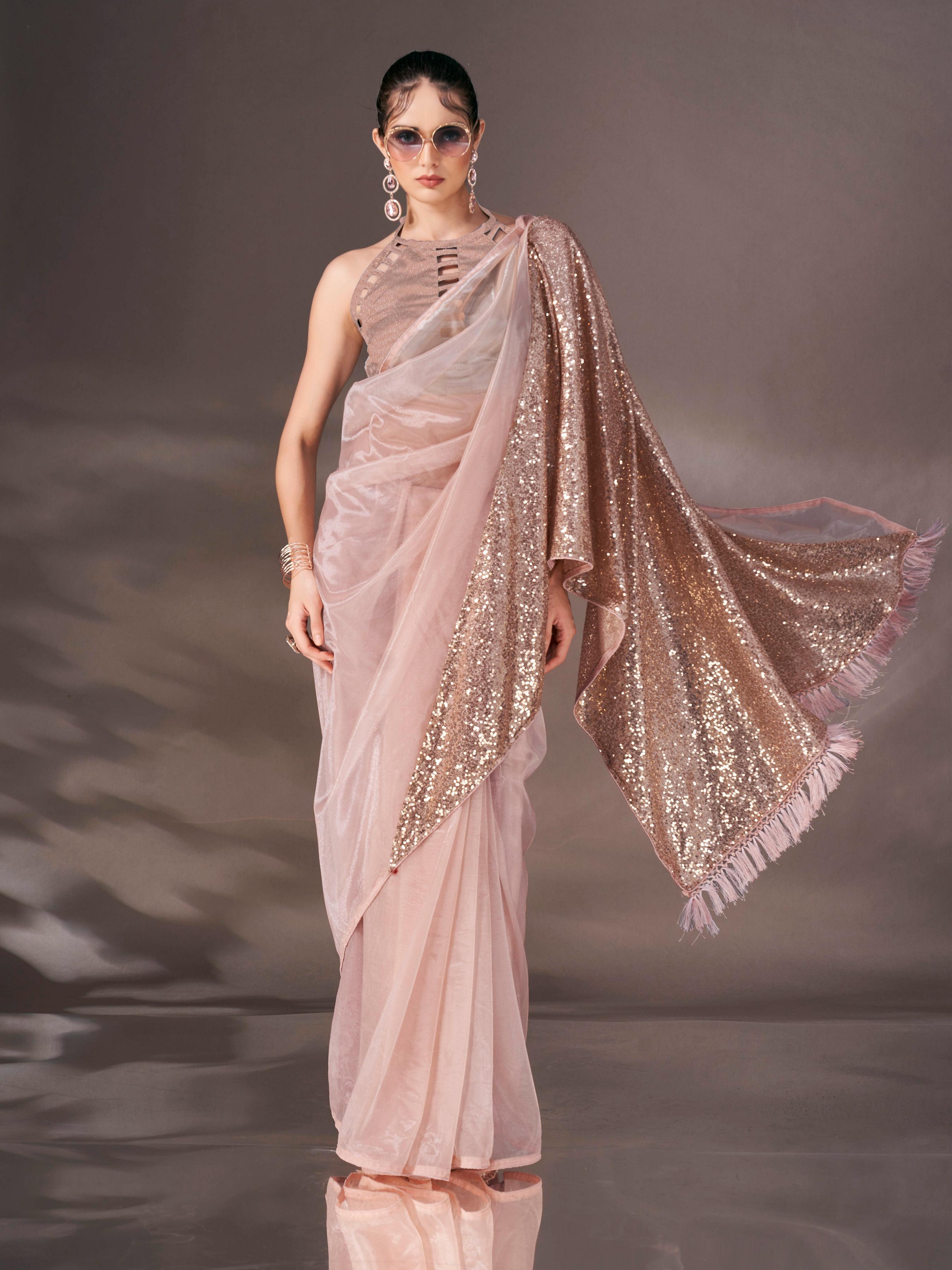 Beige colored shimmer net saree with sequin embroidery