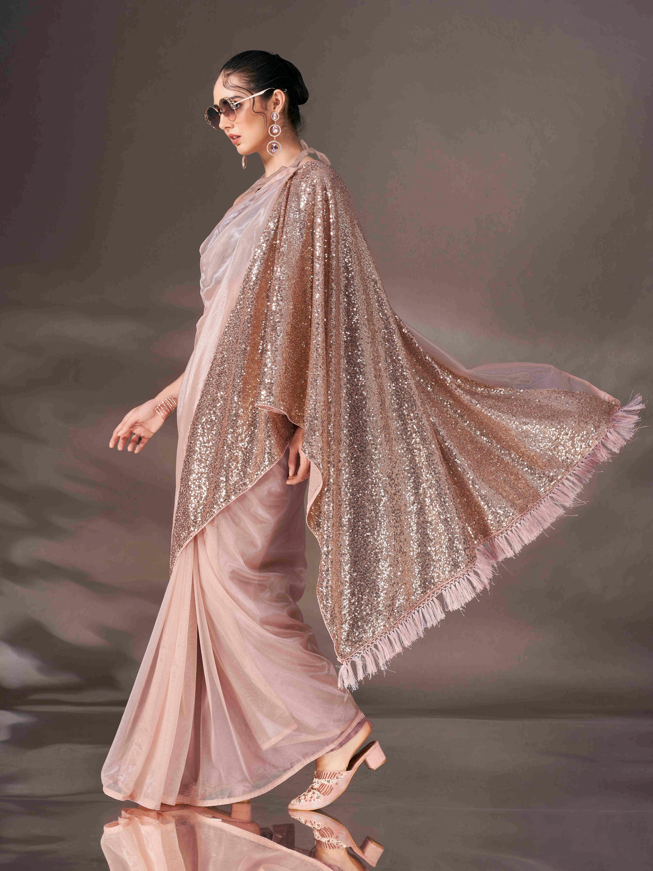 Beige colored shimmer net saree with sequin embroidery