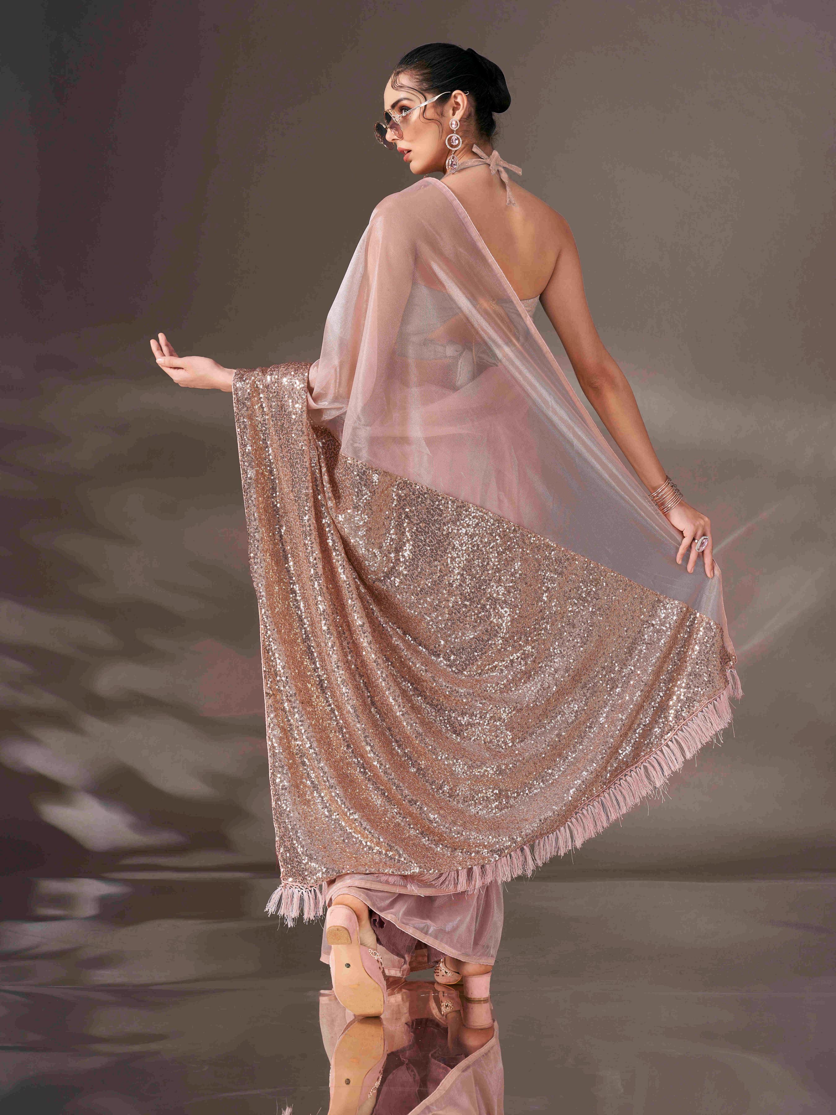 Beige colored shimmer net saree with sequin embroidery