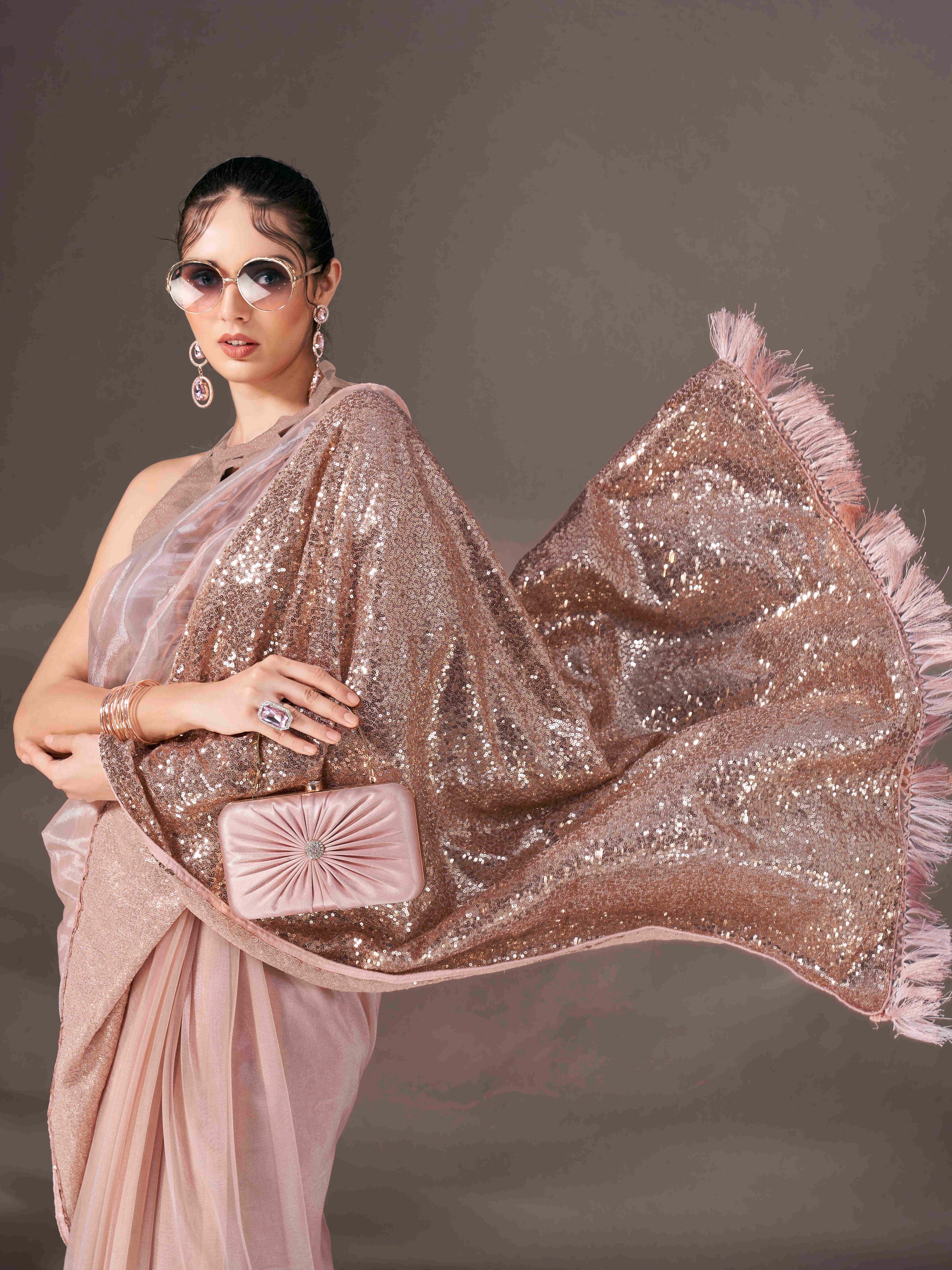 Beige colored shimmer net saree with sequin embroidery