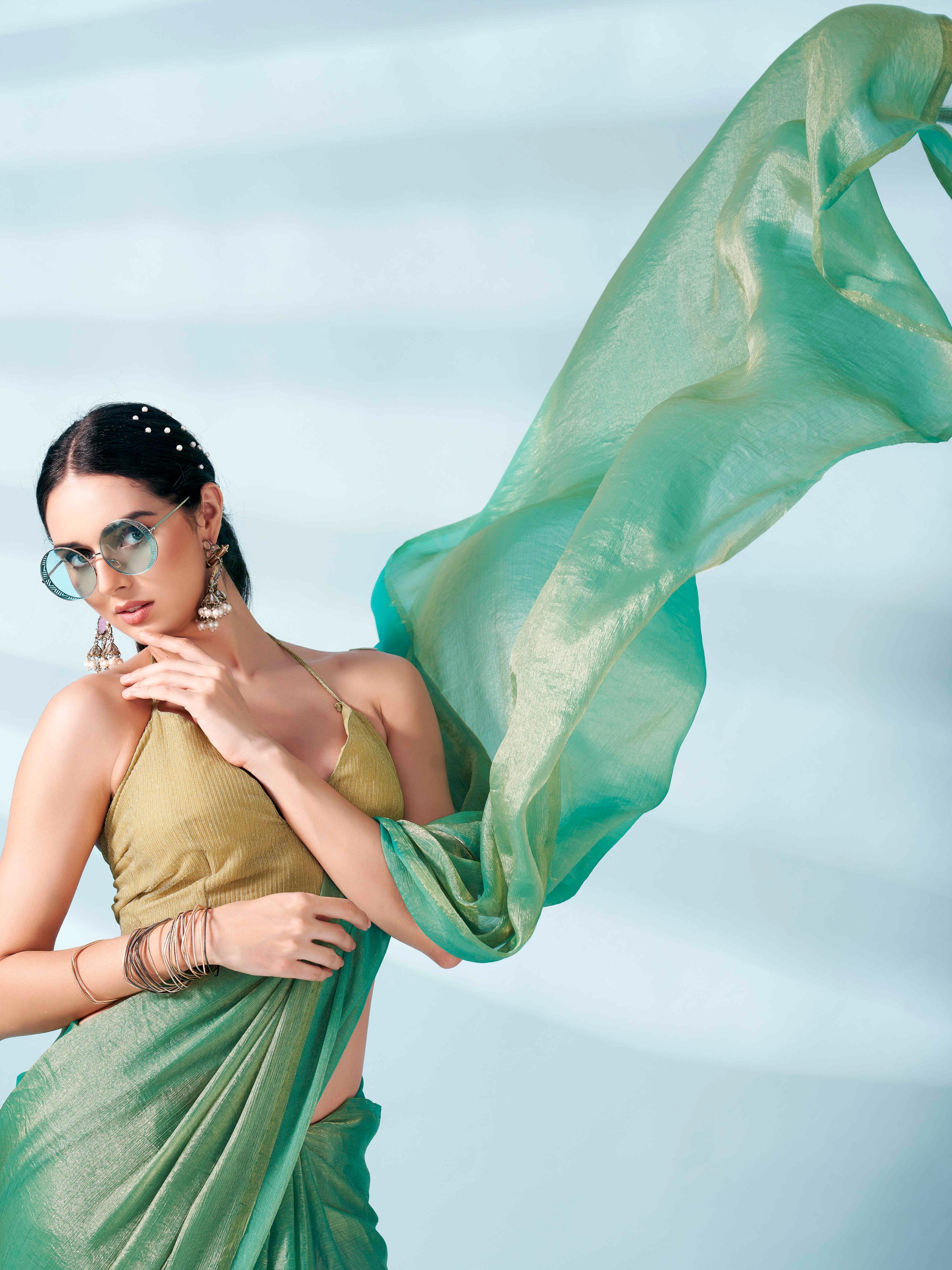 Sea green and gold two tone shimmer chiffon saree with tassles in pallu and fancy lycra blouse