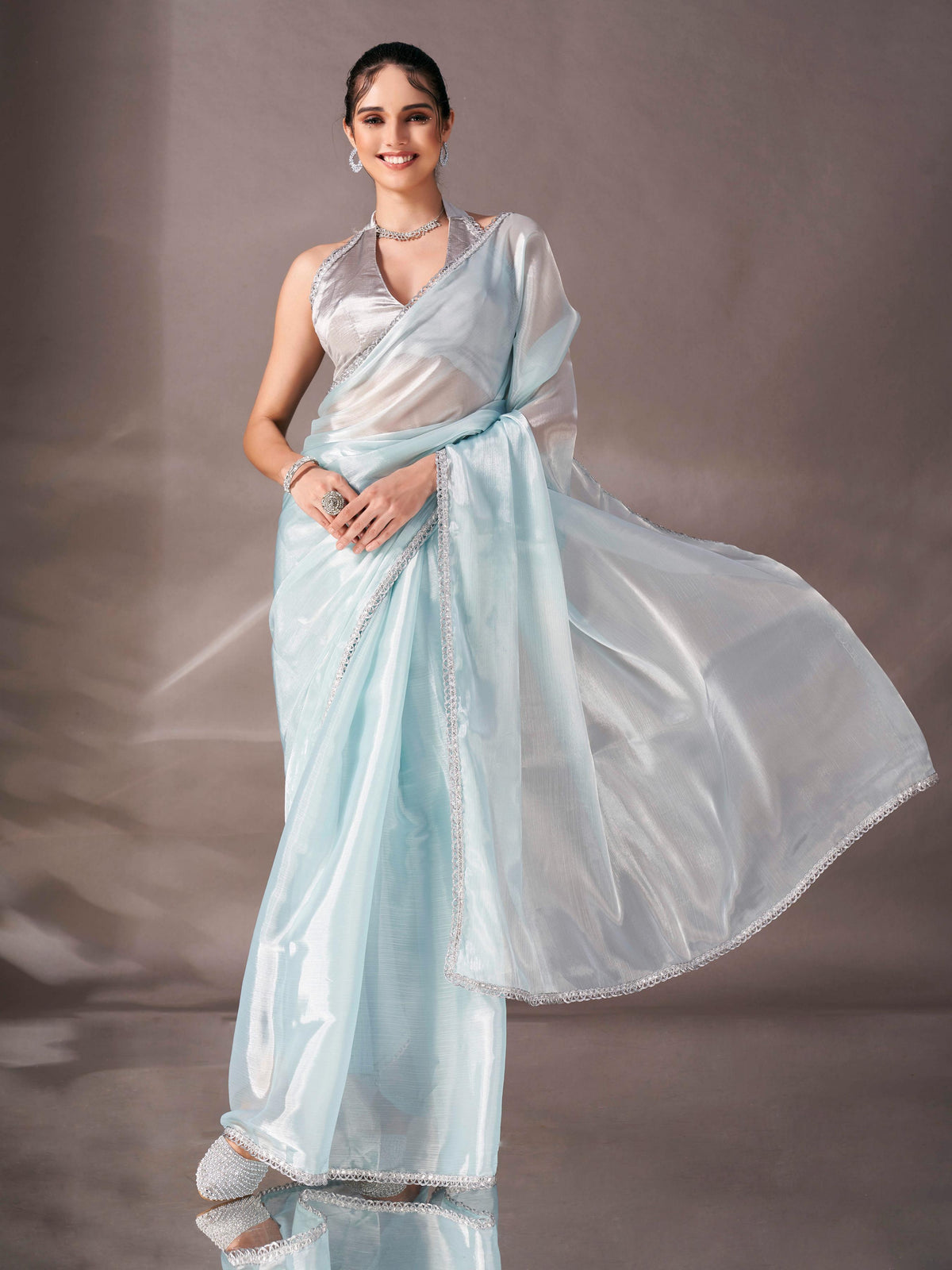 Sky blue colored shimmer satin saree with embellished lace