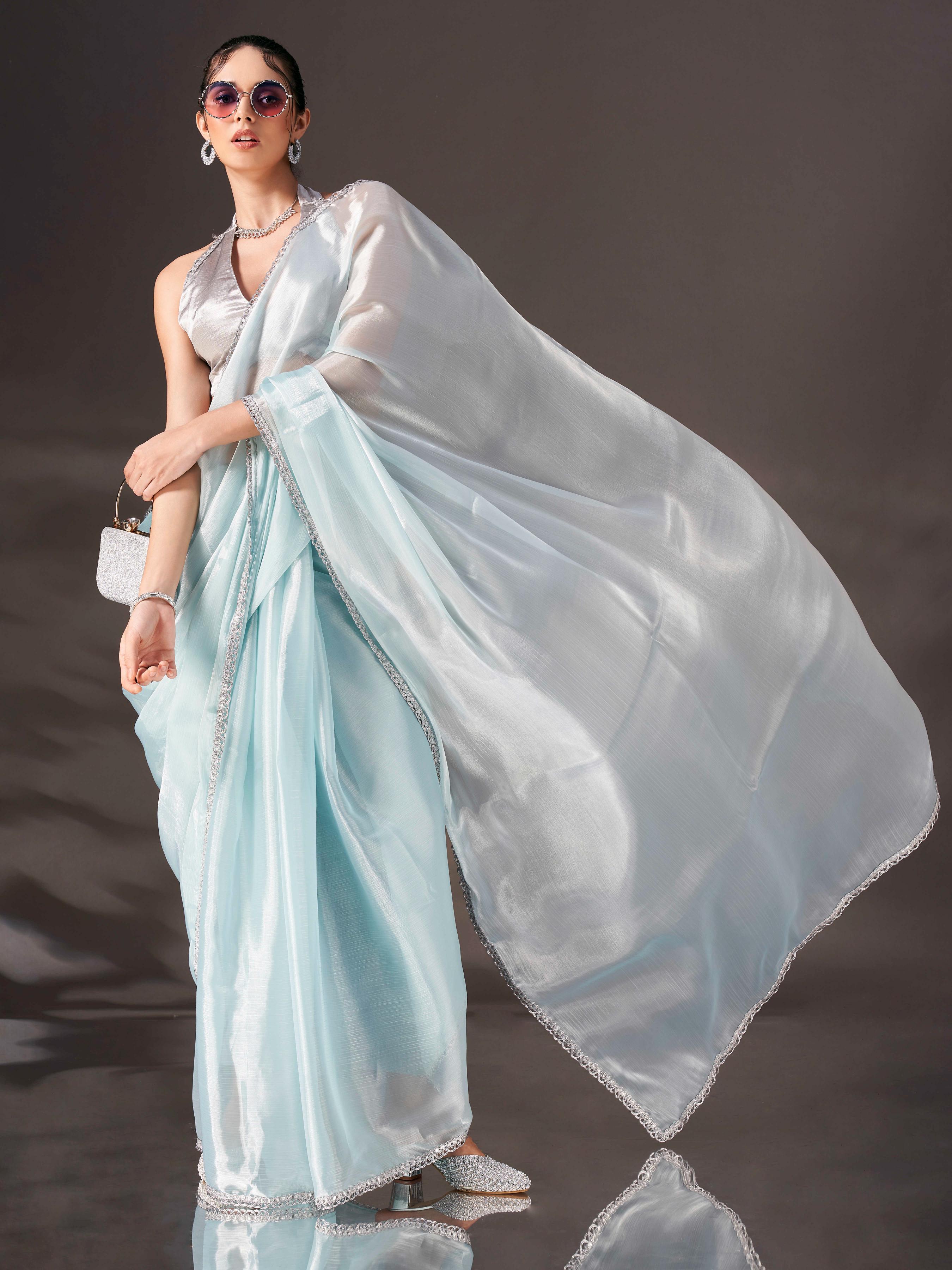 Sky blue colored shimmer satin saree with embellished lace