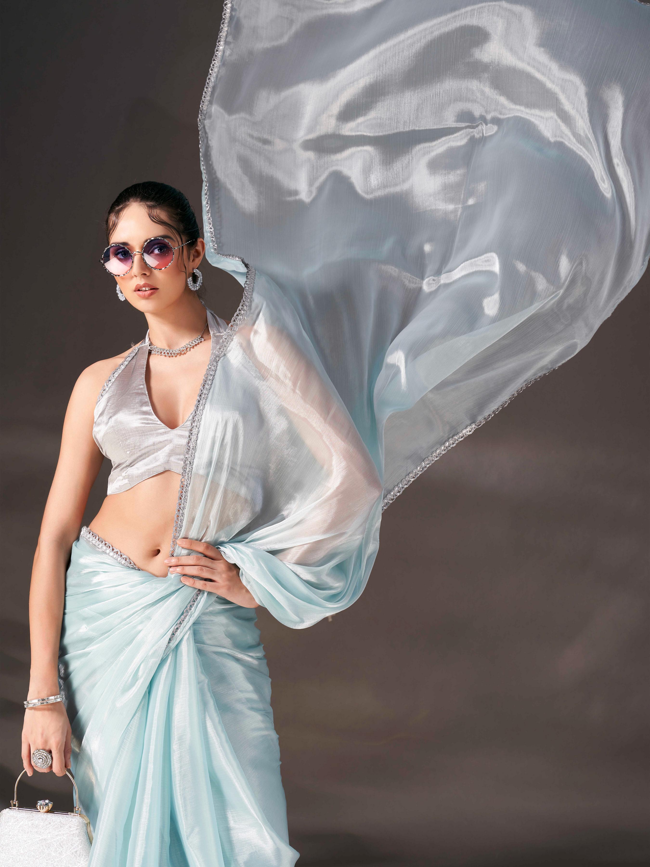 Sky blue colored shimmer satin saree with embellished lace