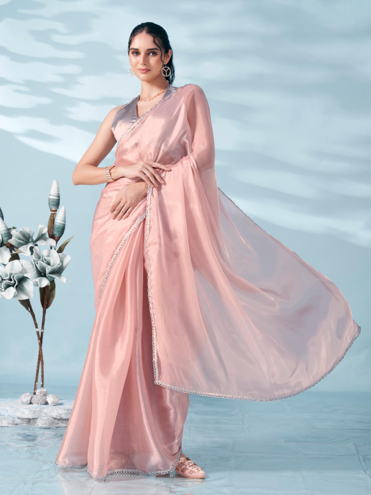 Peach colored shimmer satin saree with embellished lace