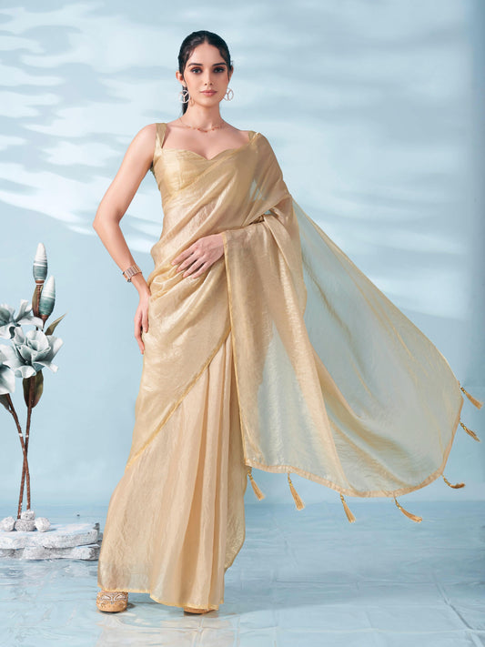 Beige colored satin saree with tassles on pallu