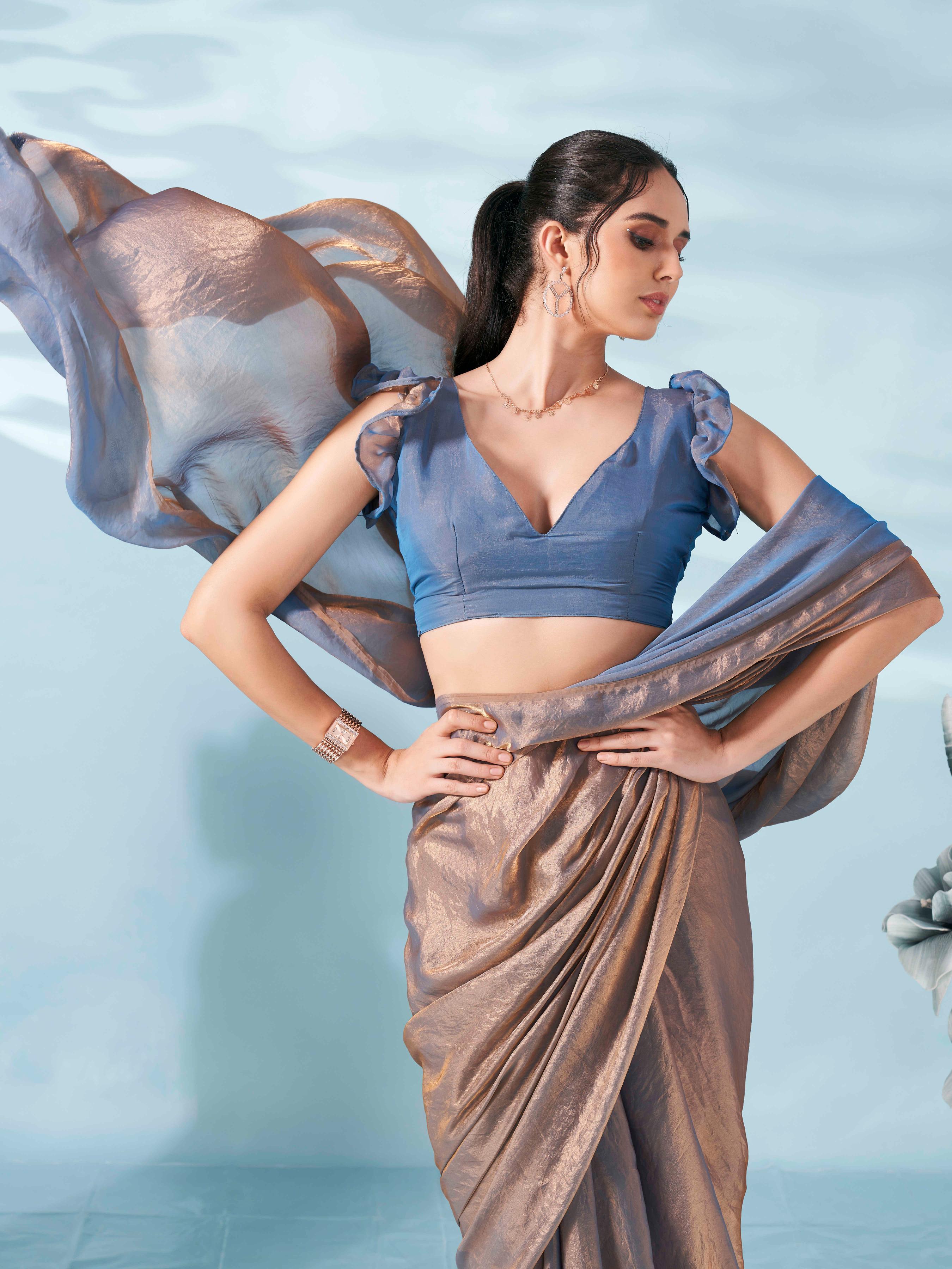 Two tone bronze and blue colored satin saree with tassles on pallu