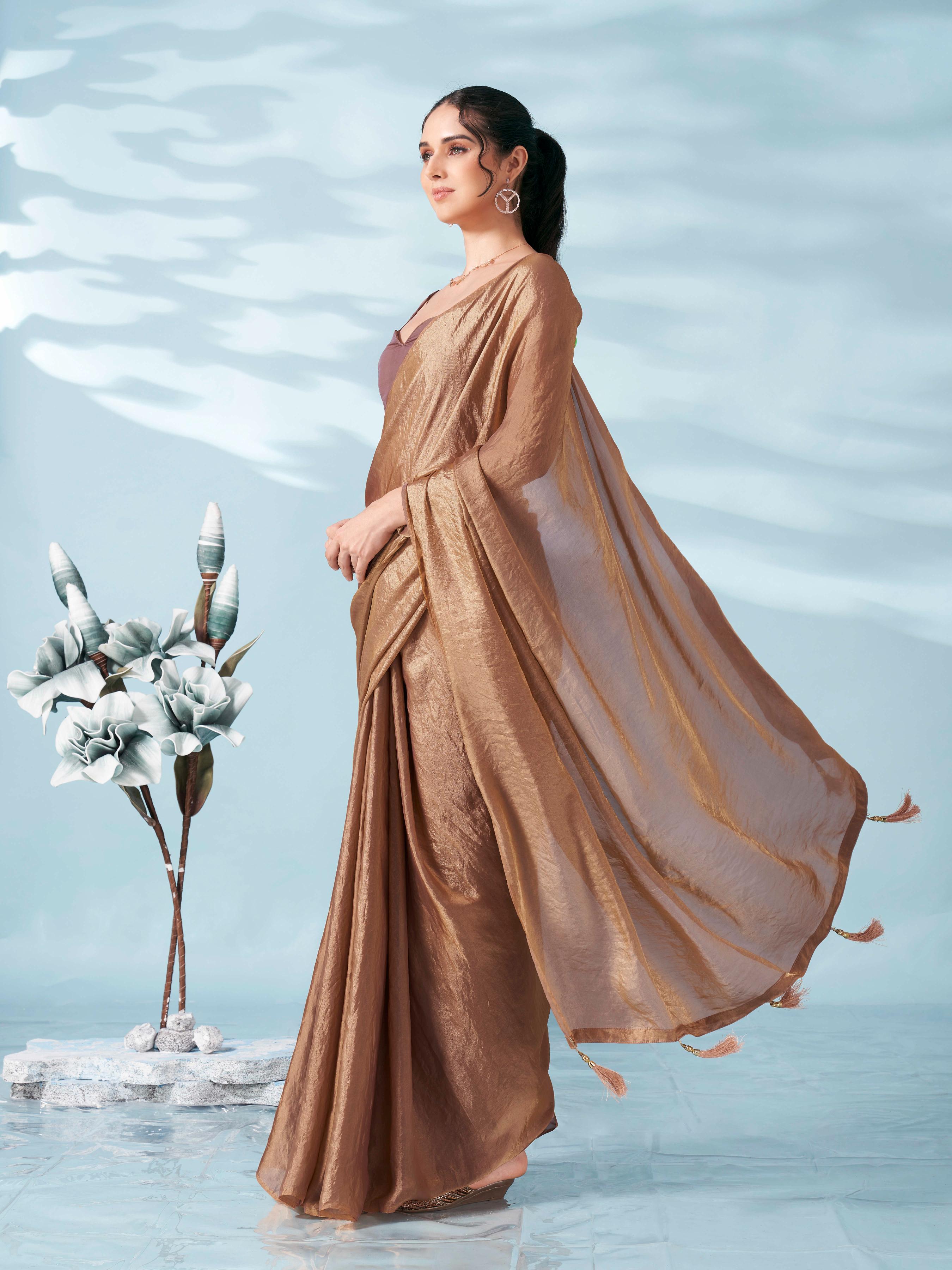 Two tone camel brown colored satin saree with tassles on pallu